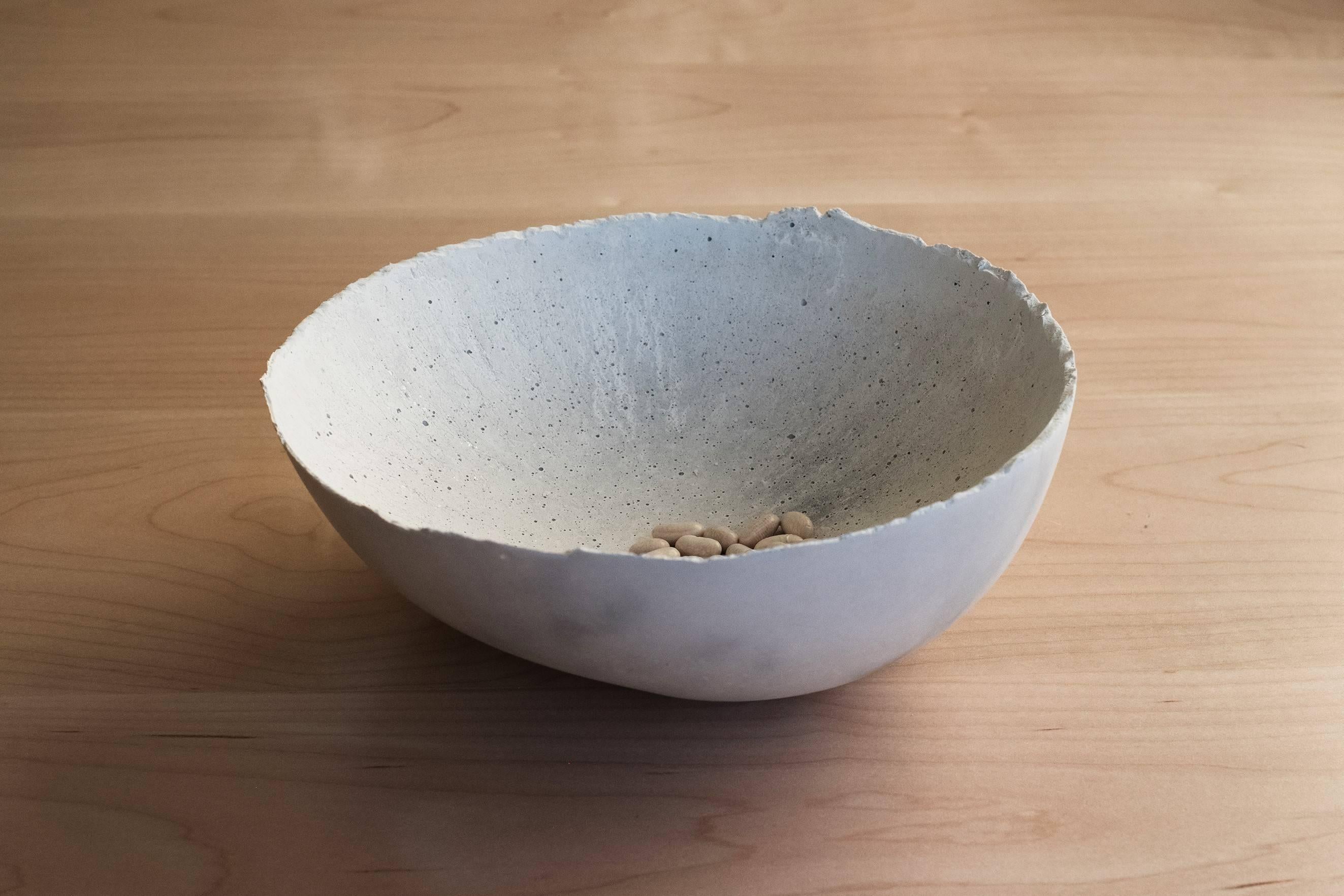 A collection of 200 unique bowls, the concrete series by UMÉ Studio expresses the tension between heavy concrete and its delicate edge generated by hand pouring. While one assumes concrete should be strong and durable, it is, at its core, fragile.