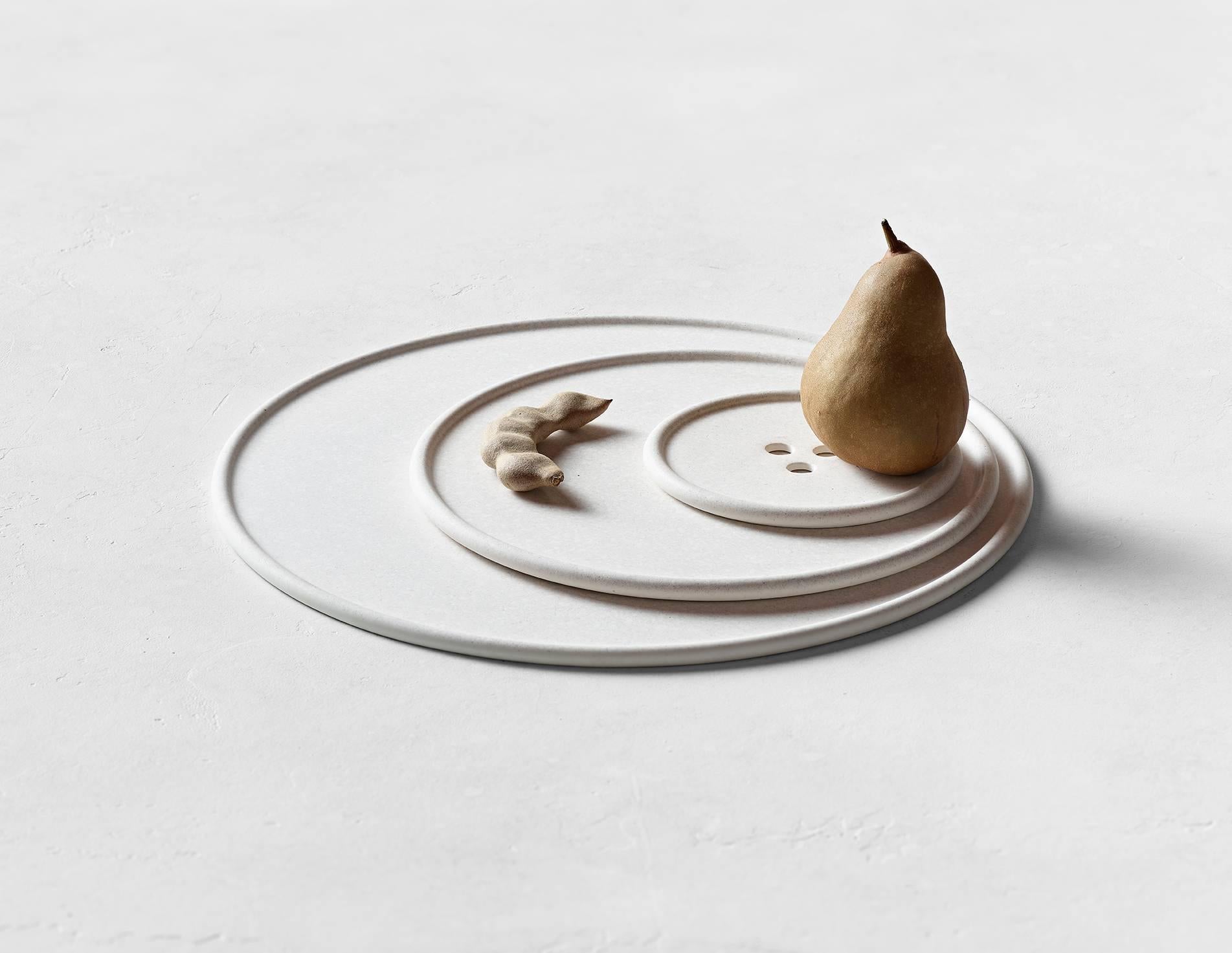 Cast in one pour, this dish is formed like a button to showcase your everyday favorites. Hand-mixed with different minerals and natural pigments, the Bouton carries subtle textures on its surface. As the concrete settles uniquely for each pour, no