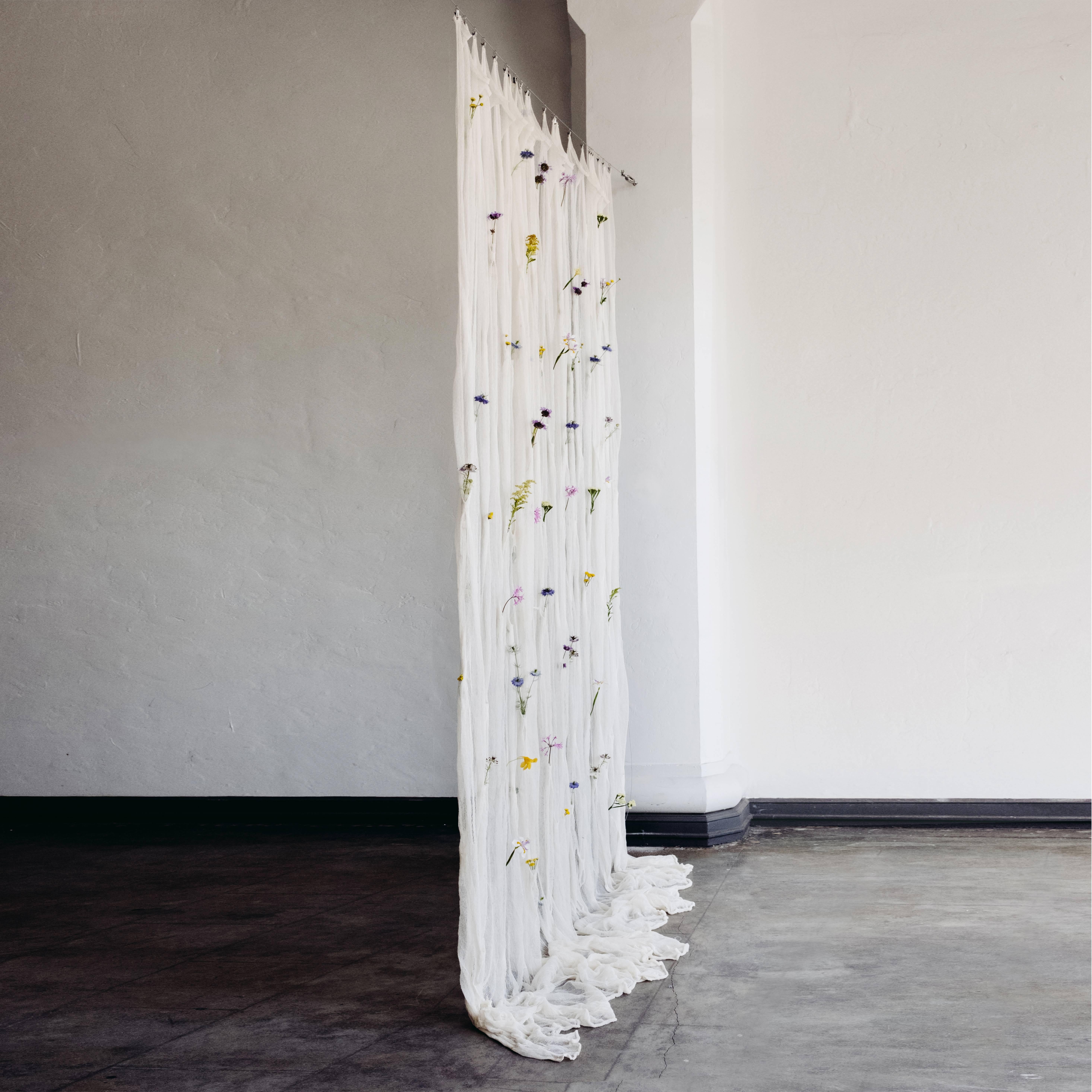 An ever-changing living vertical divider, the draped flowers curtain contains over 100 pockets where fresh flowers can be placed, transforming the space it inhabits by offering a landscape of seasonality and personal contexts.

The limited run of