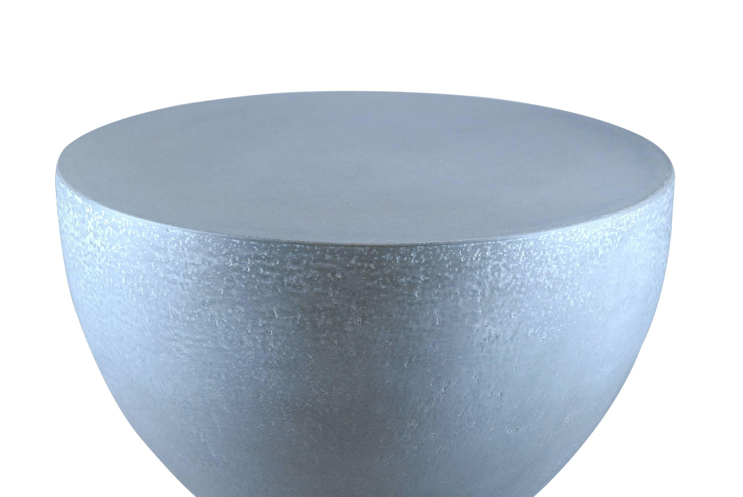 This highly refined hourglass concrete accent table is perfect for a foyer. It's smooth lines are welcoming and color options can be selected by the client. A custom top can also be added if additional surface space is needed. In addition to the