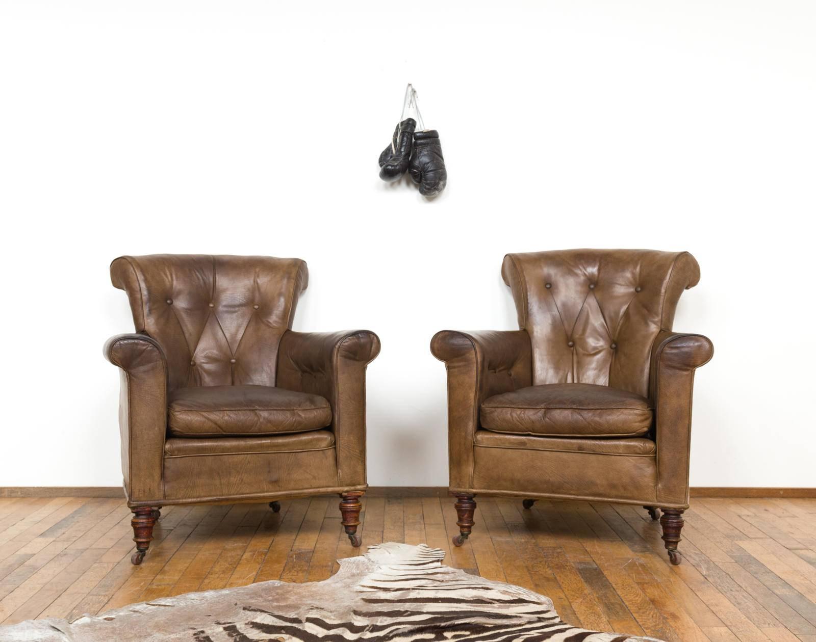 Set containing two club chairs dating from the beginning of the 20th century. The set has been reupholstered somewhere late 20th century. The chairs are filled up with horsehair and are very comfortable. The caramel brown leather has a beautiful