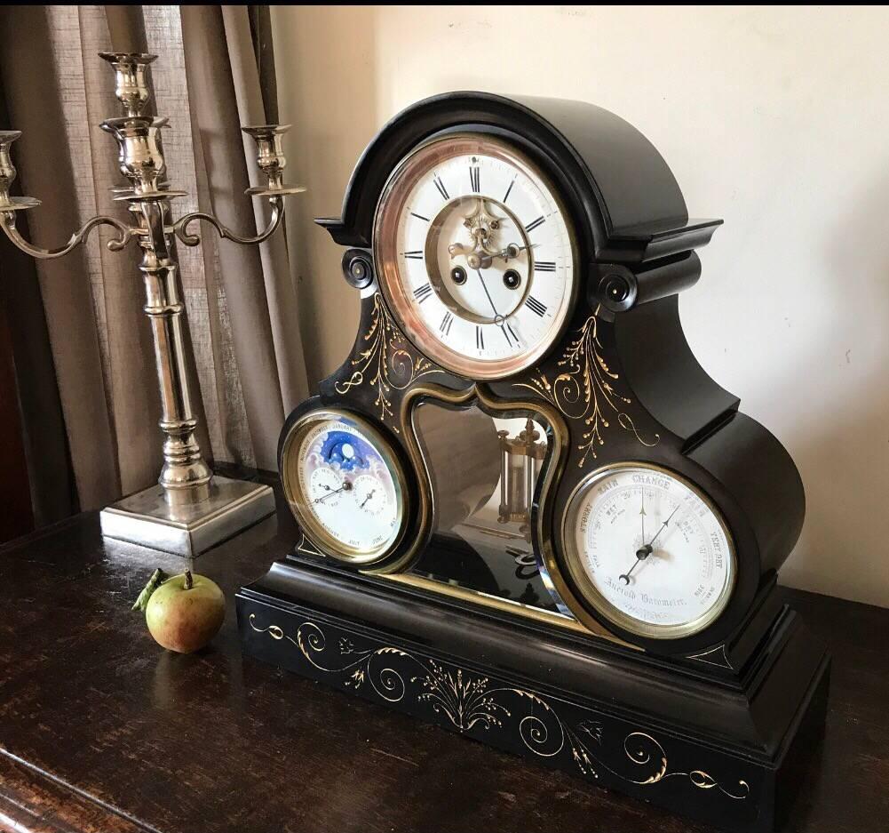 Very large and tri-form marble and slate perpetual calendar clock with month, day, date and rolling moon phase subsidiary dials, circa 1870.

Month duration bell striking movement with visible jewelled Brocot escapement and mercury compensating