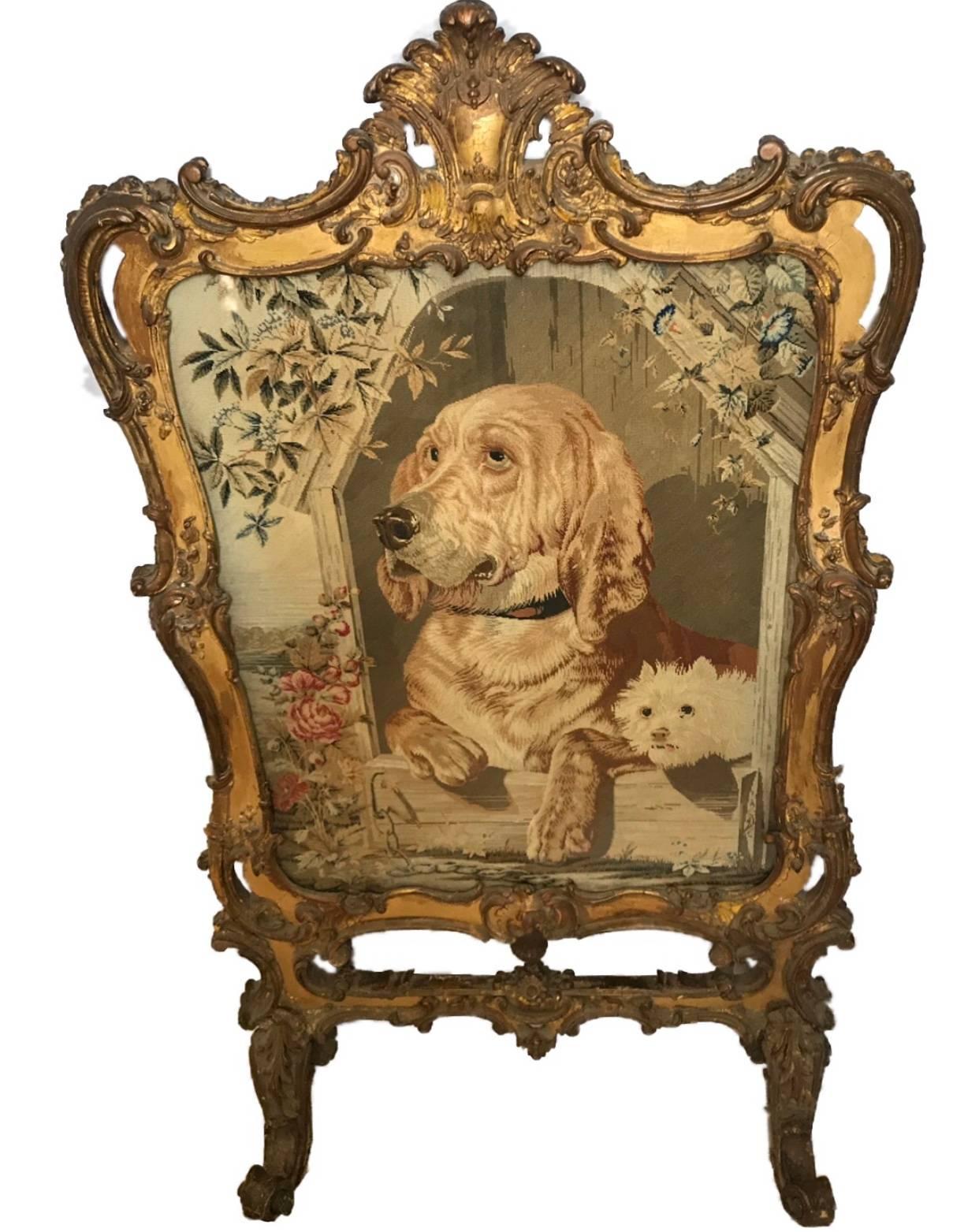 Fine and very imposing Regency giltwood tapestry fire screen.
The centre glazed tapestry depicting two dogs housed within a kennel surrounded by the carved giltwood frame with scrolling acanthus leaves.