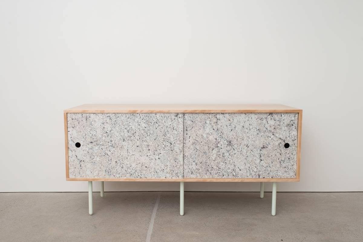 Basic Bitch is a simple box credenza made from Birch plywood and powder coated steel legs. The sliders can be interchanged or customized and are shown in white, gray, or stone laminate, and also in bronze mirror acrylic. A classic but simple design