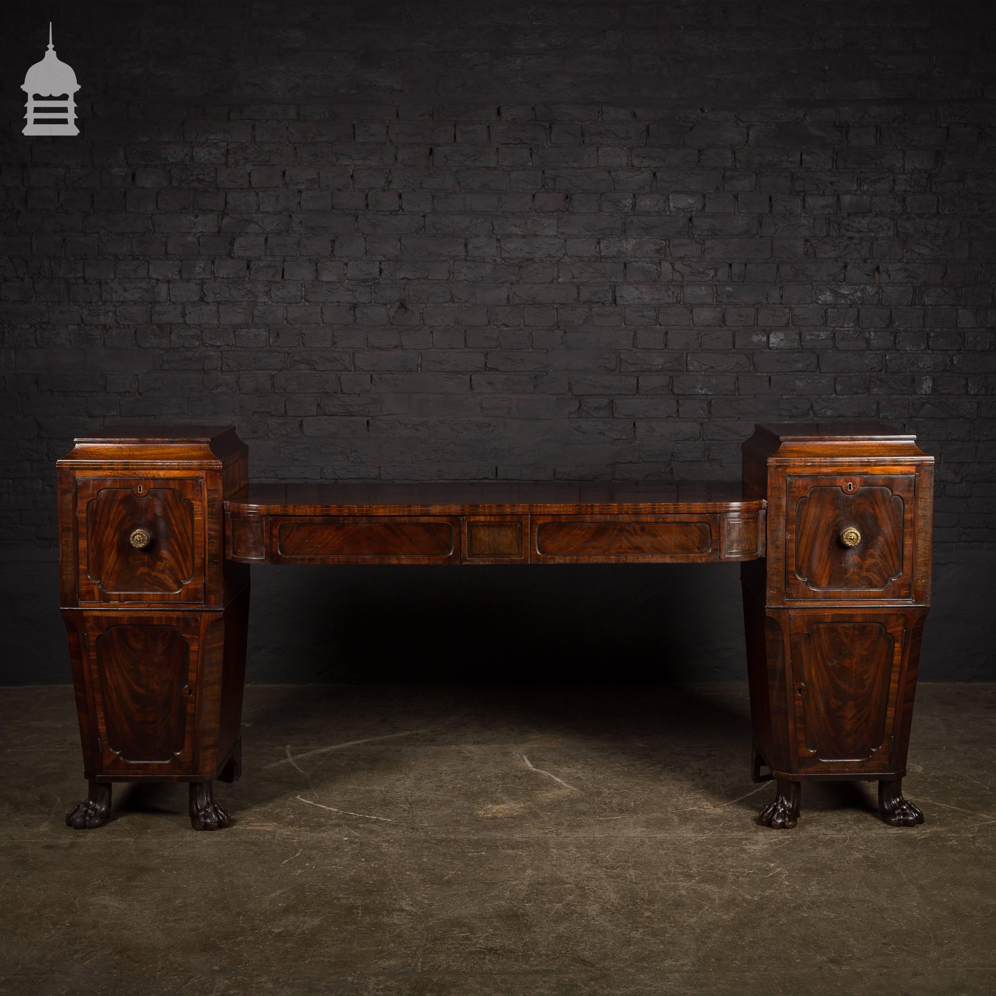 Regency flame mahogany pedestal sideboard with lions paw feet.