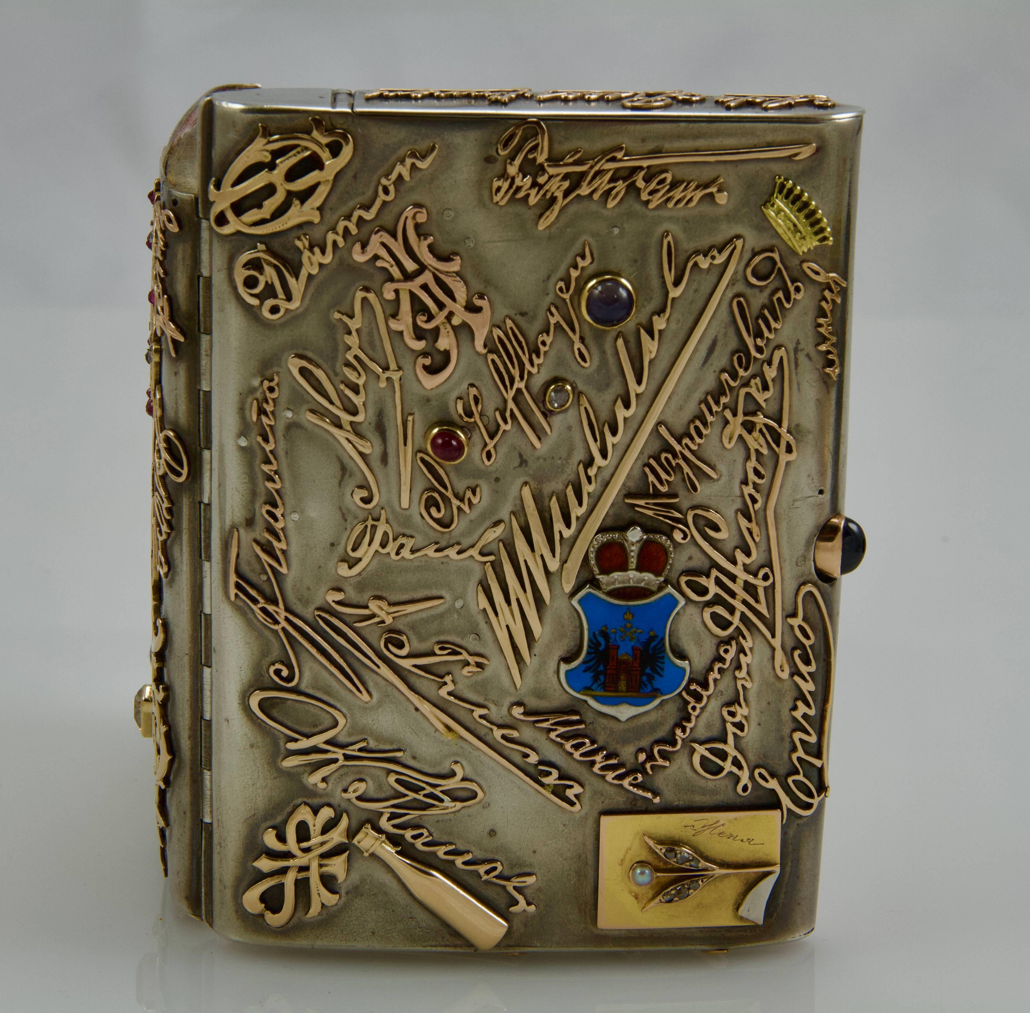 A matt silver rectangular cigarette-case comprising a match compartment and inside an Art Nouveau frame for three pictures allowing separation between the two parts of case.  
Totally on face and reverse applied with 37 gold monogrammes and