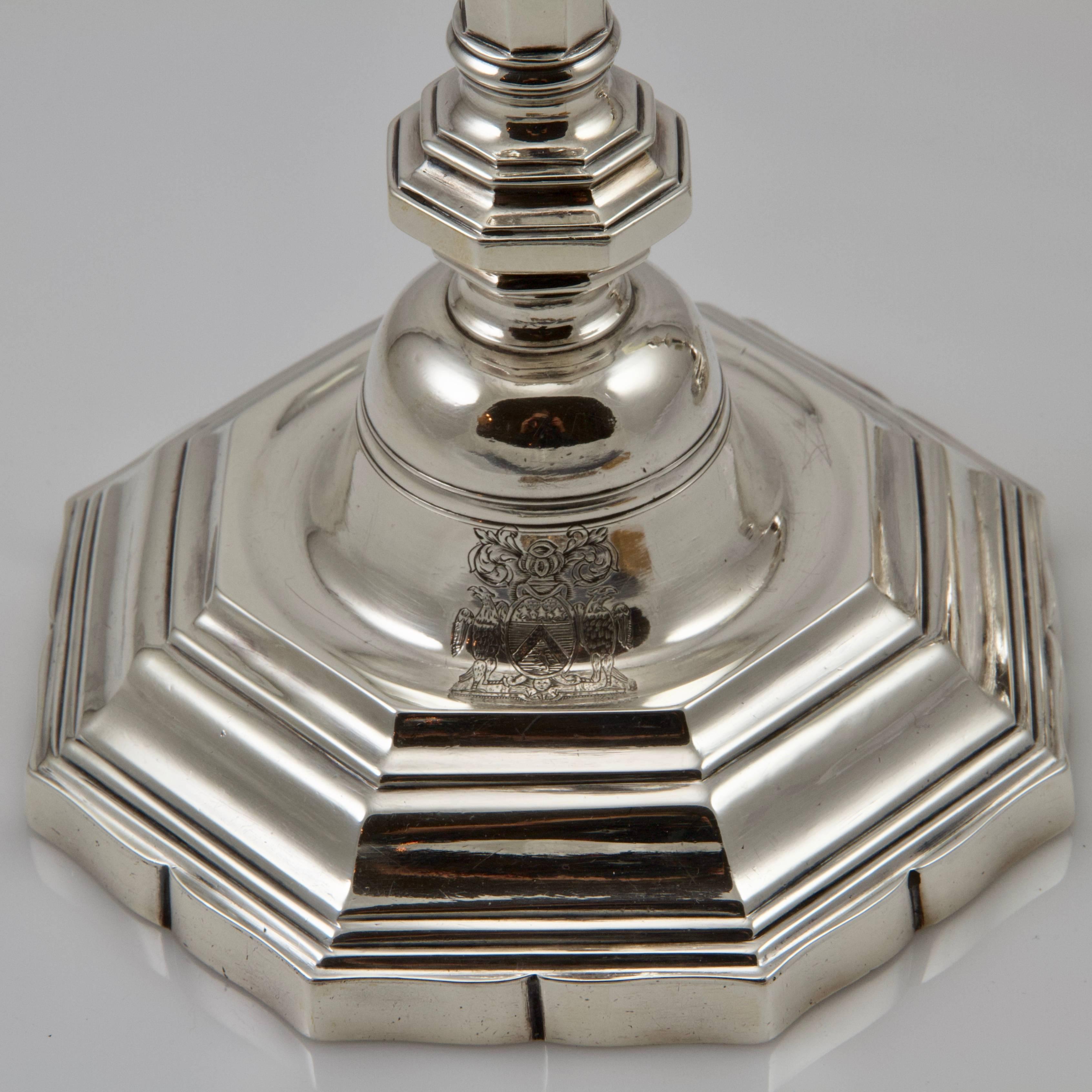 Very simple and chic table candlesticks pair in silver on hexagonal foot with a curving shape edge with a triangular baluster stem swelling out towards to the top. 
In the most typical and pur main of the Louis XV style. 
Engraved on the foot with