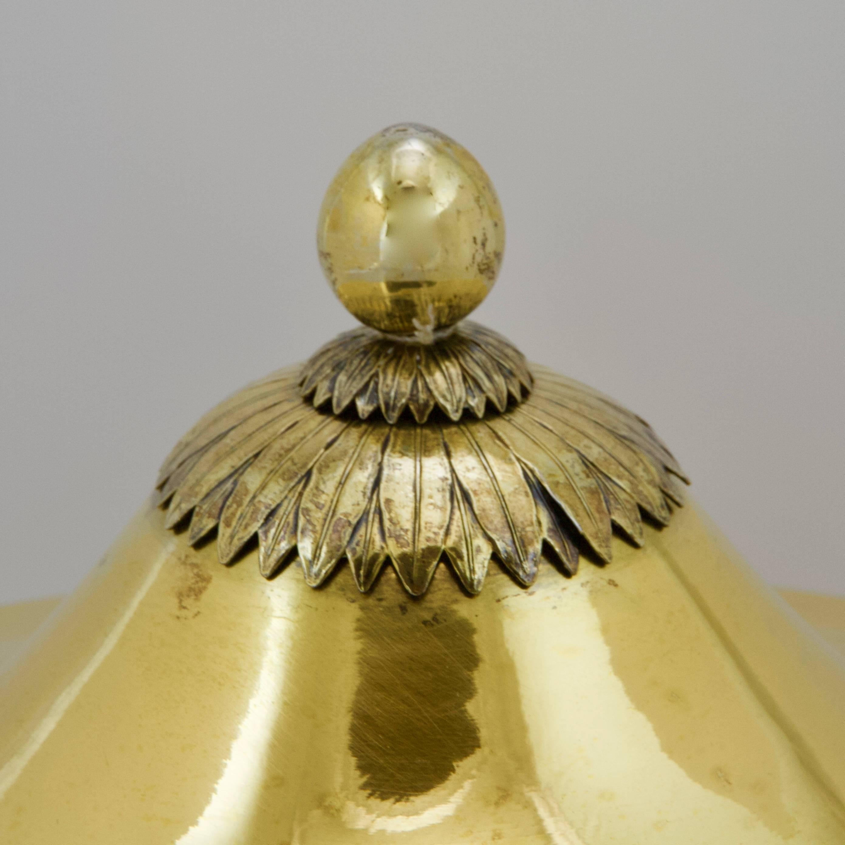 A very rare silver-gilded antique Russian meat-dish.
A pagoda shaped cover on a round bowl screwed to the dish.
Bordered with palms. Cover decorated with a large laurel fruit onto a double laurel palm terrace.
Hand-engraved on the bottom with
