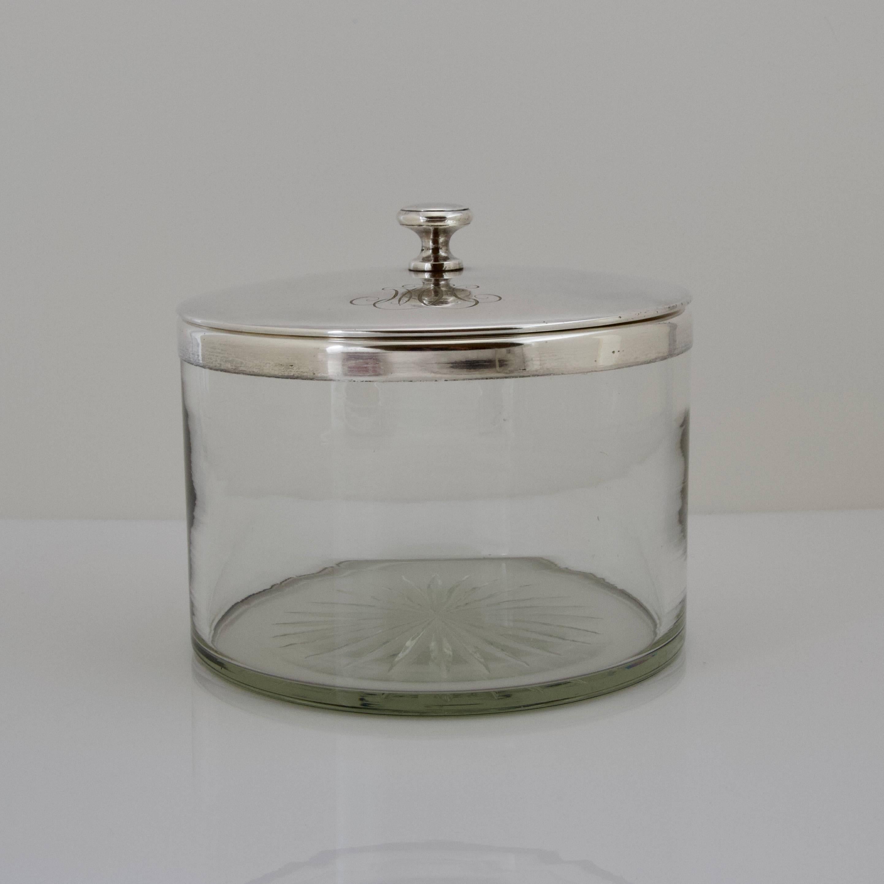 A large caviar bowl in two parts, a glass round bowl, for ice, circled by silver plated frame with two handles containing a bowl for caviar and its cover ciphered MH resting on a brace base. 
Each bottom is engraved with a rosette.
Capacity: 2