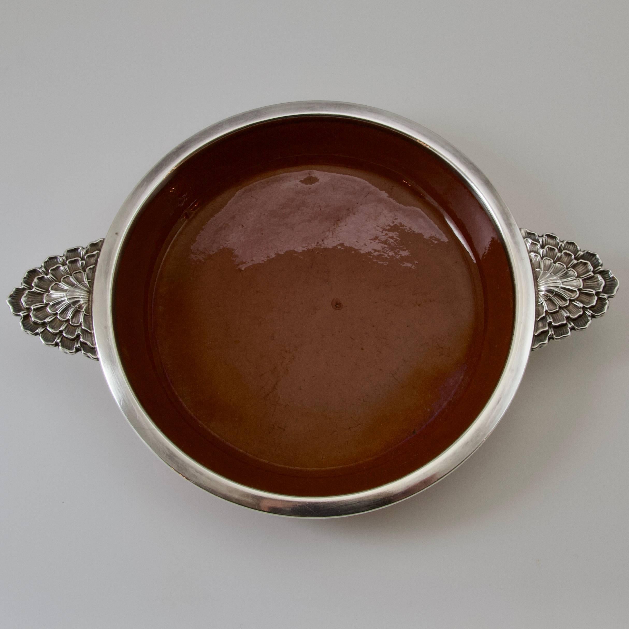 A rare and in very good condition sterling silver and terracota plate (for Creme Caramel)
Terracota glazed inside and natural on the reverse.
Circled by a large silver sterling frame. Two handles in molded and chiseled silver sterling look like