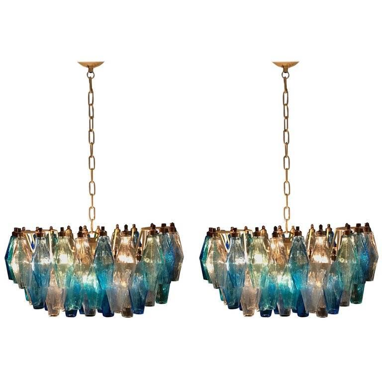 Each chandelier consists of 52 colored Poliedri of Murano. Ice, blue and aquamarine. Measures: cm H 80, L 50, W 35 height lights without chain 30 cm.