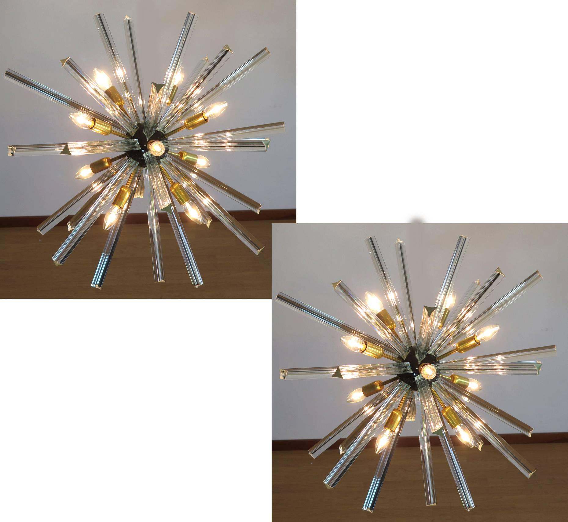 Sputnik chandelier surrounding 30 crystal glass 'triedri' prisms radiating from a centre black metal nucleus. Brass lamp holder.
Dimensions: 47.25 inches (120 cm) height with chain; 29.50 inches (75 cm) diameter.
Dimension glasses: 15 prisms