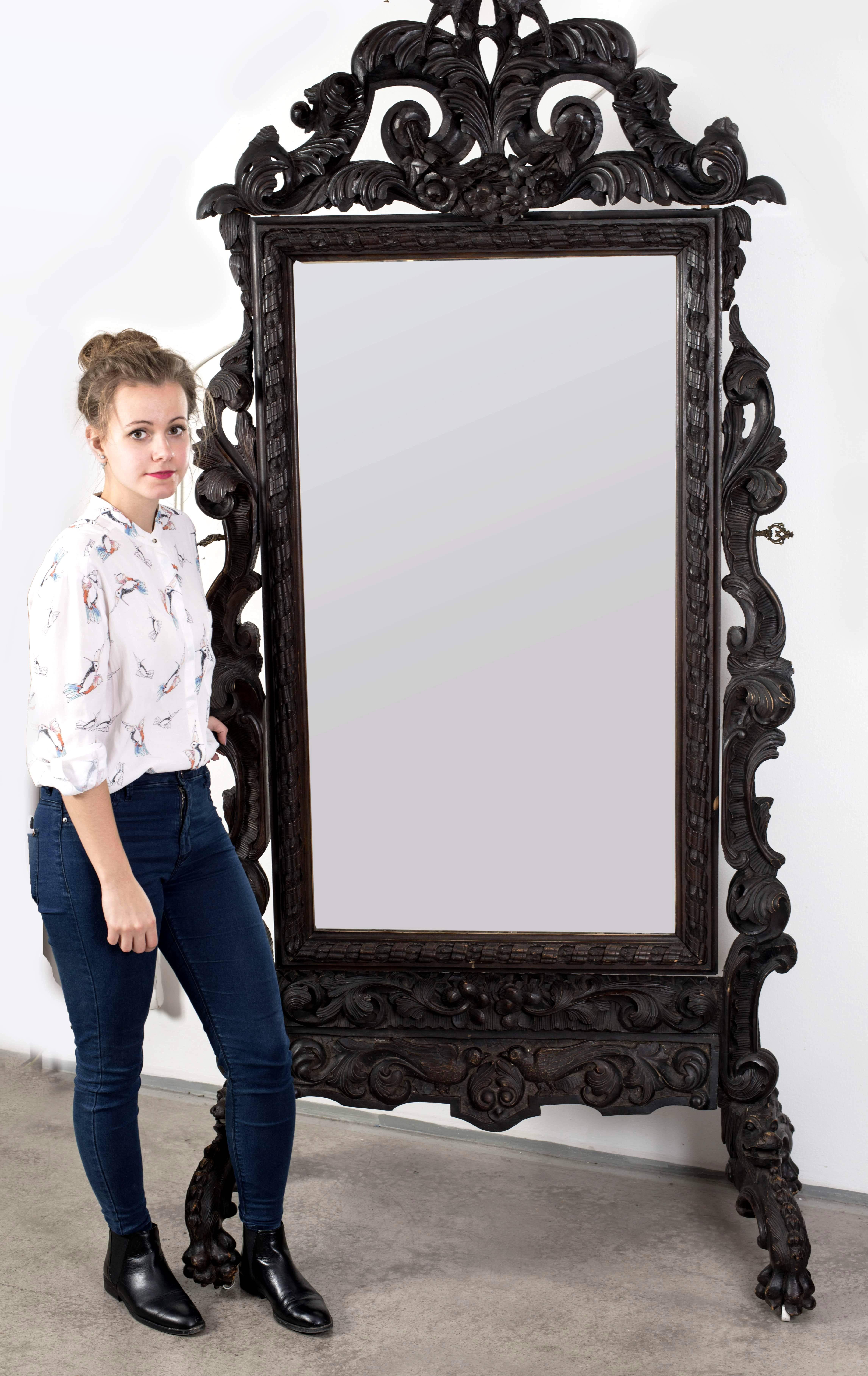 Beautiful carved and ebonized wooden mirror. Of the same aristocratic environment, the sofa and two armchairs upholstered in cardinal velvet. Made in Hungary in the second half of the 19th century.