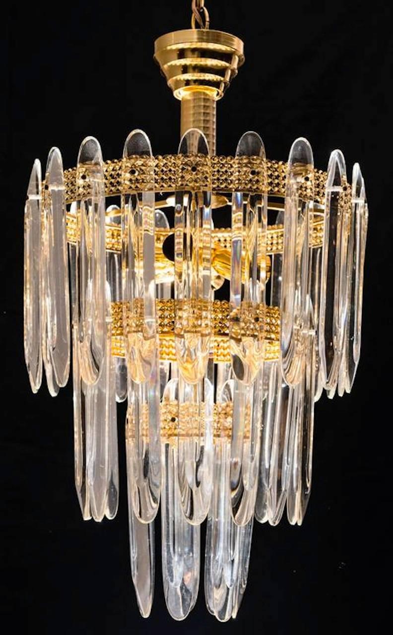 Three-tier shaped crystals on brass-plated frame. Three-tier, 13 lights.