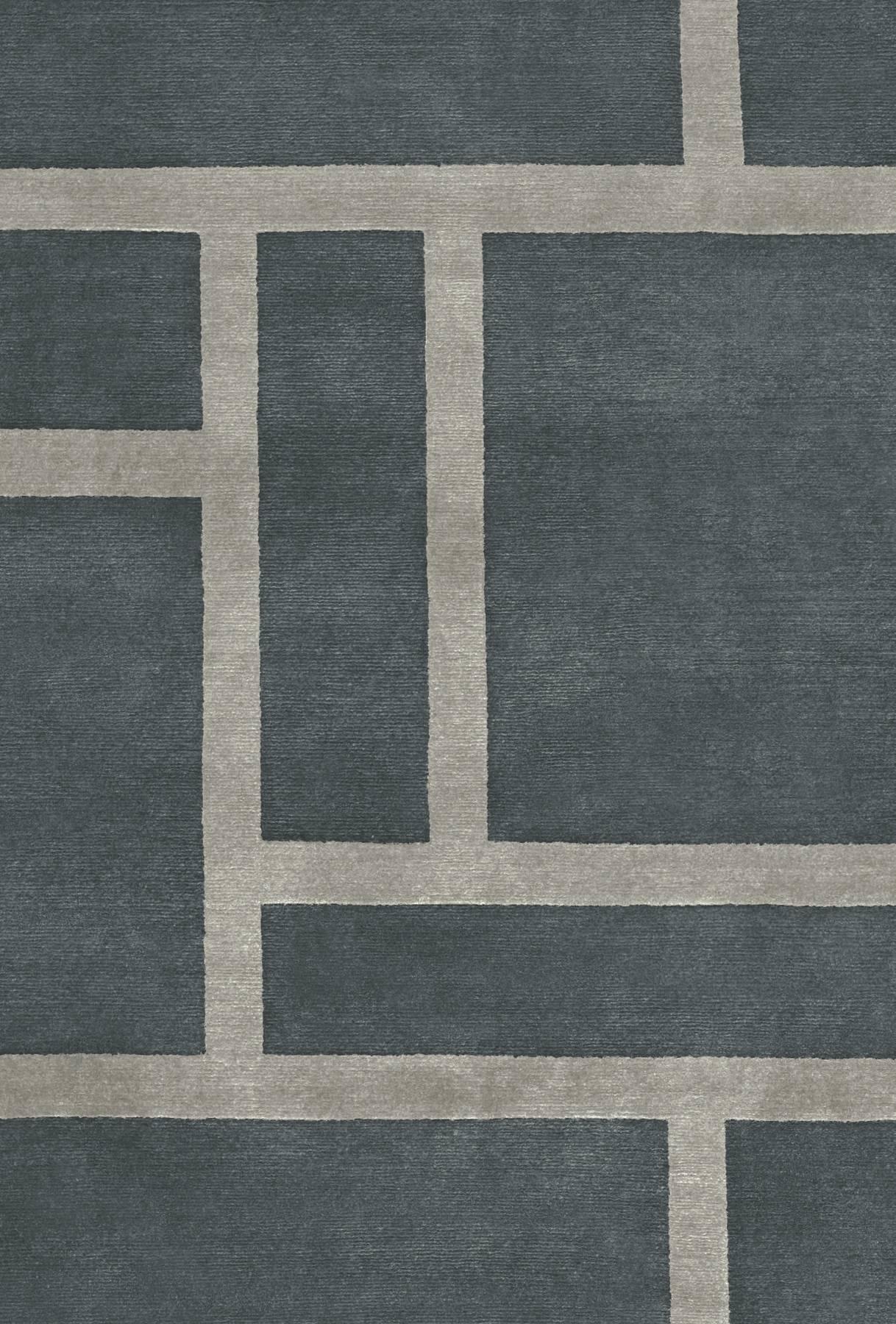 Loom rug is hand-knotted in Nepal in wool and silk (70-30%). 
This rug can only be pre-ordered.
Quality: 100 knots by square inch.
Base color dark grey, pattern light grey. 
Low pile, raised pattern.
 