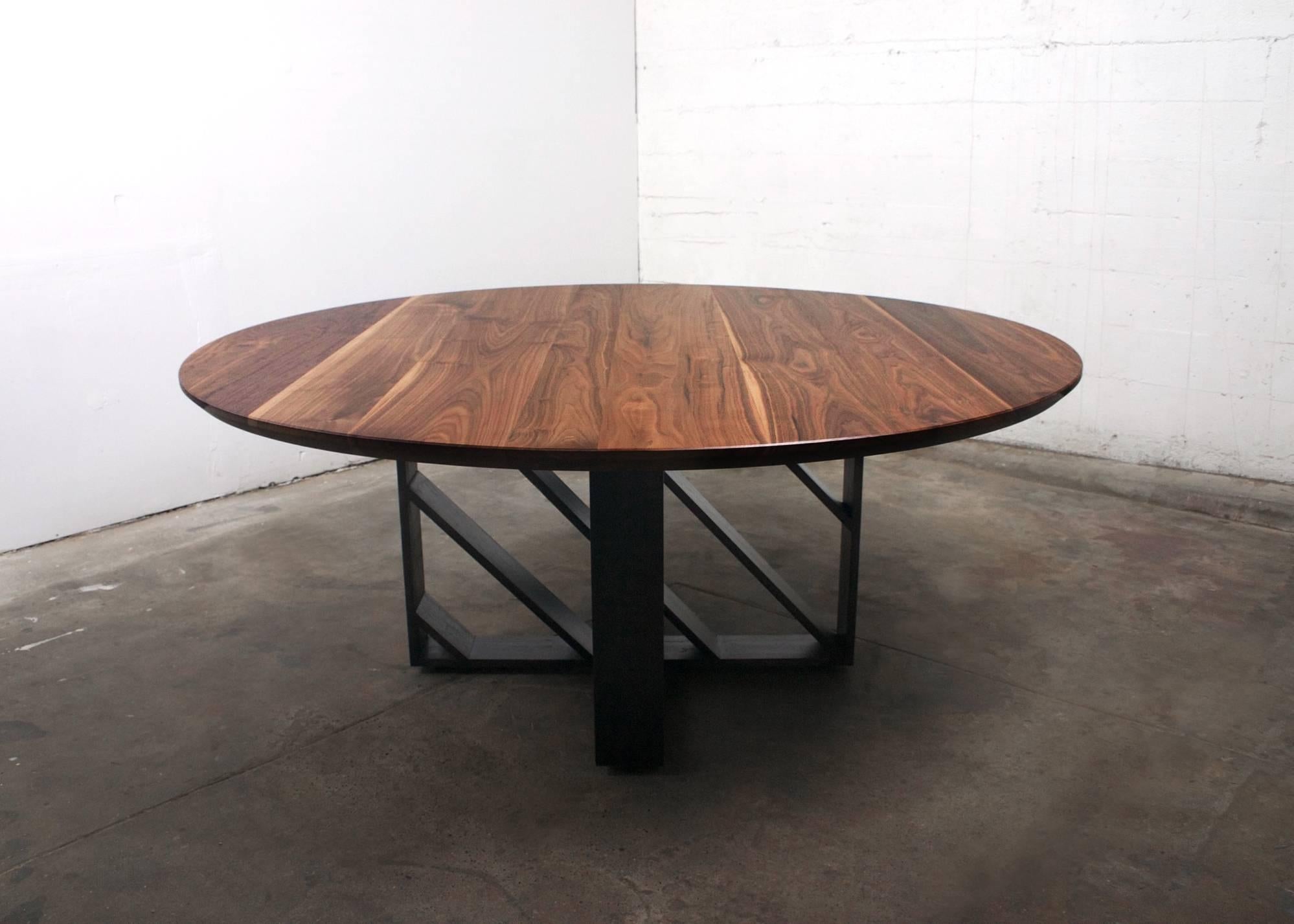 This modern steel and wood table looks different from every angle because of the steel planes movement of light and shadow. Made from American Black Walnut and 1/2” x 5” hot rolled steel plate with a live blackened finish. 

Made-to-order and fully