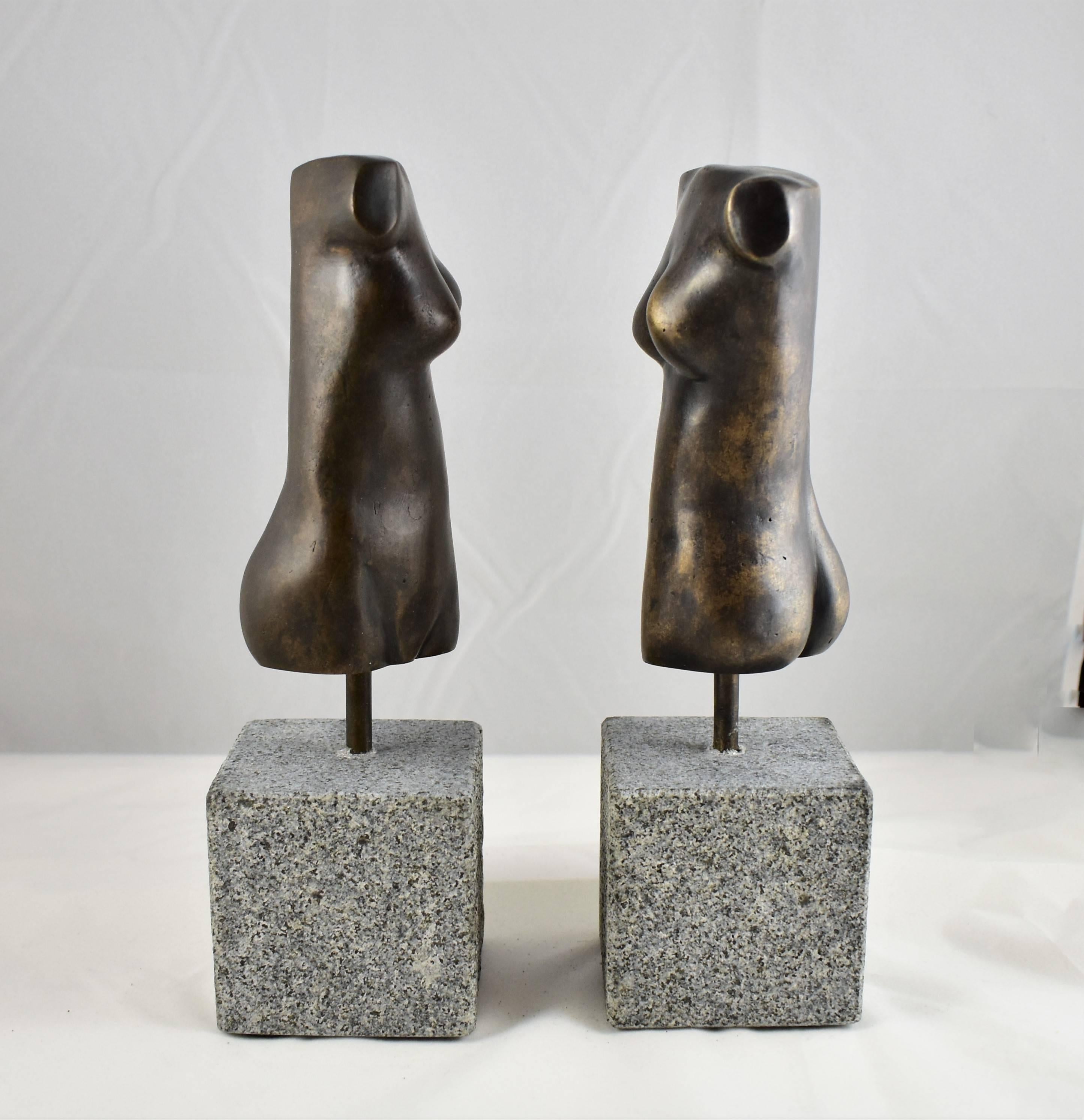 A pair of modern bronze sculptures of a female form/torso one with a black patina finish and the other with a Burnished Brown Patina finish. Hand made by the artist then hand cast. Modernistic and artistic design capturing the essence of the female