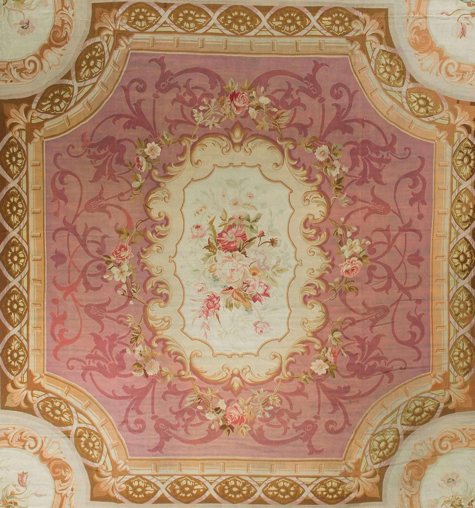 A difficult to find square Aubusson, with a wonderful composition. The central ivory medallion enclosed in a swirl of soft rose colored vines all surrounded by a glorious border in soft greens with four splendid spandrels with a floral theme.