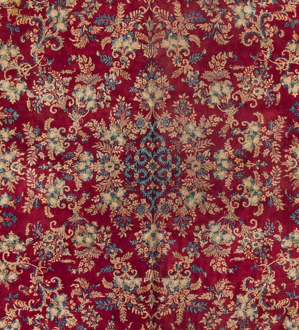 This rug is a striking piece of an unusual size. The field and border filled with floral motifs and creating a strong visual impression, that will translate in a room to create a truly wonderful look. Kirman is the capital of the province in south