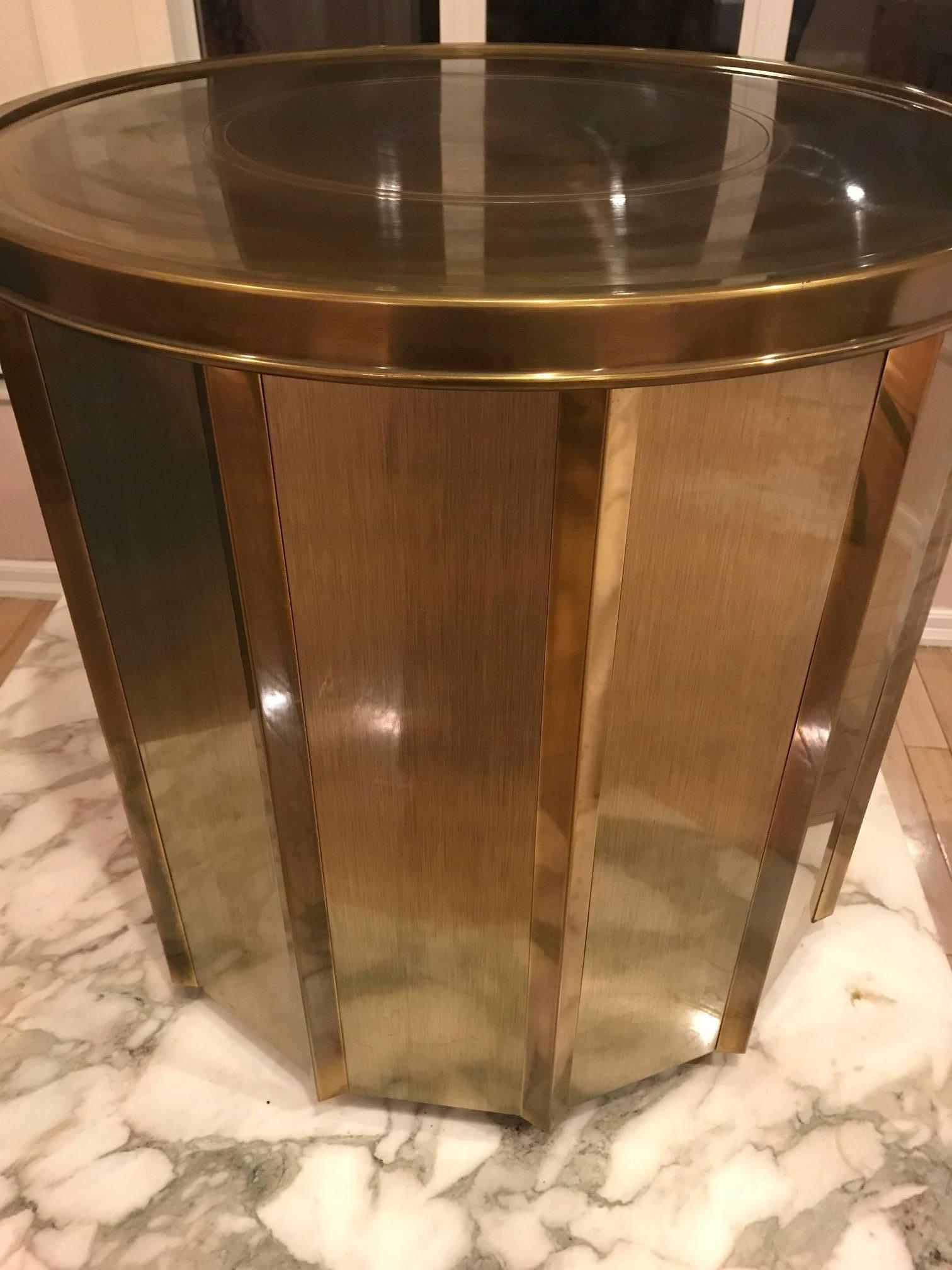 Brass dining table base in original condition with original finish, circa 1970s. This can hold a large circular glass top of substantial weight. Elegant classic and rich warm brass patina.