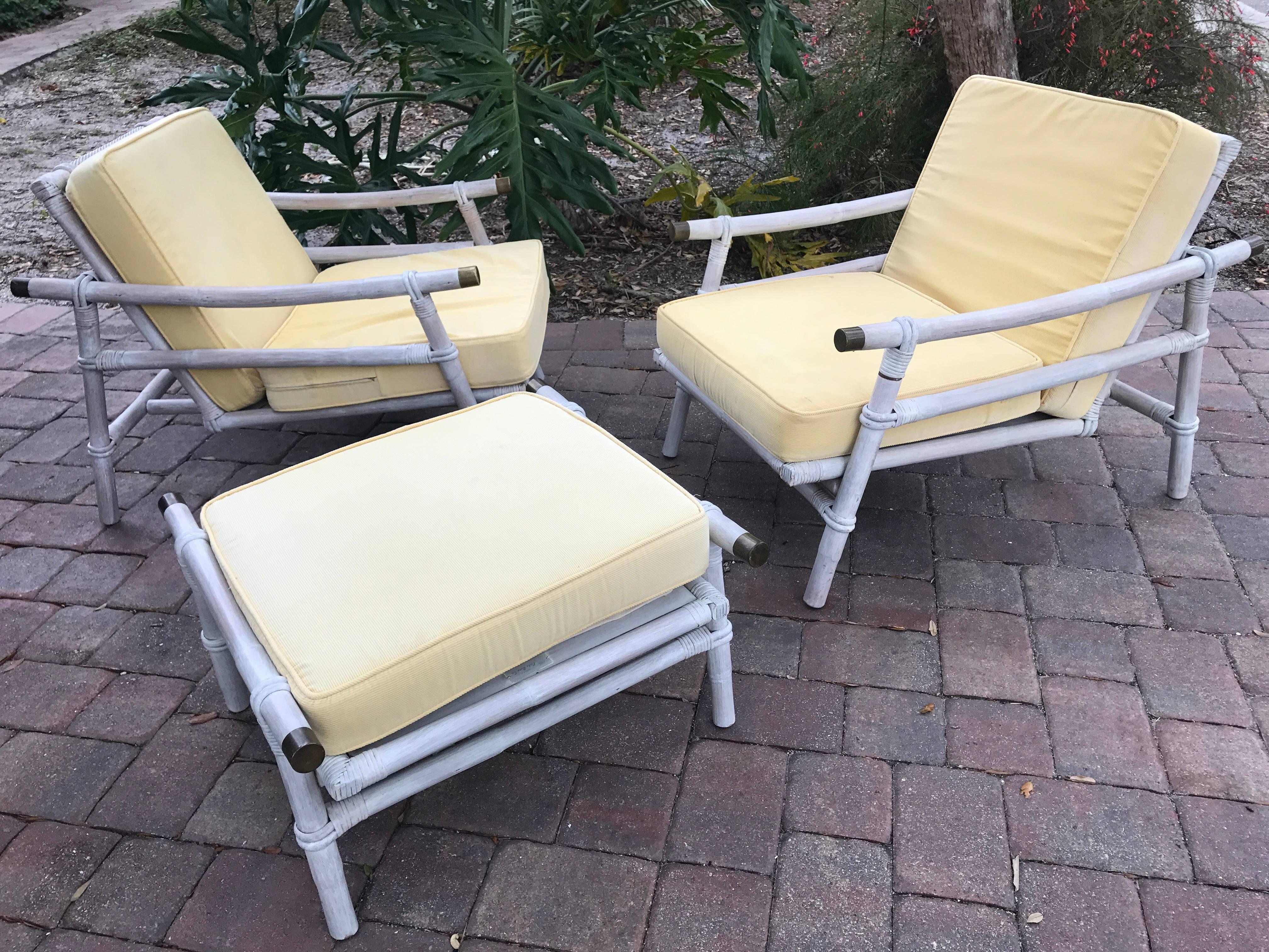 Pair of original patina lounge chairs, original condition is restored. Original cushions ready to be reupholstered in your favourite color. All original Ficks Reed tags on all the pieces. Set of two lounge chairs with matching stool. Polished brass