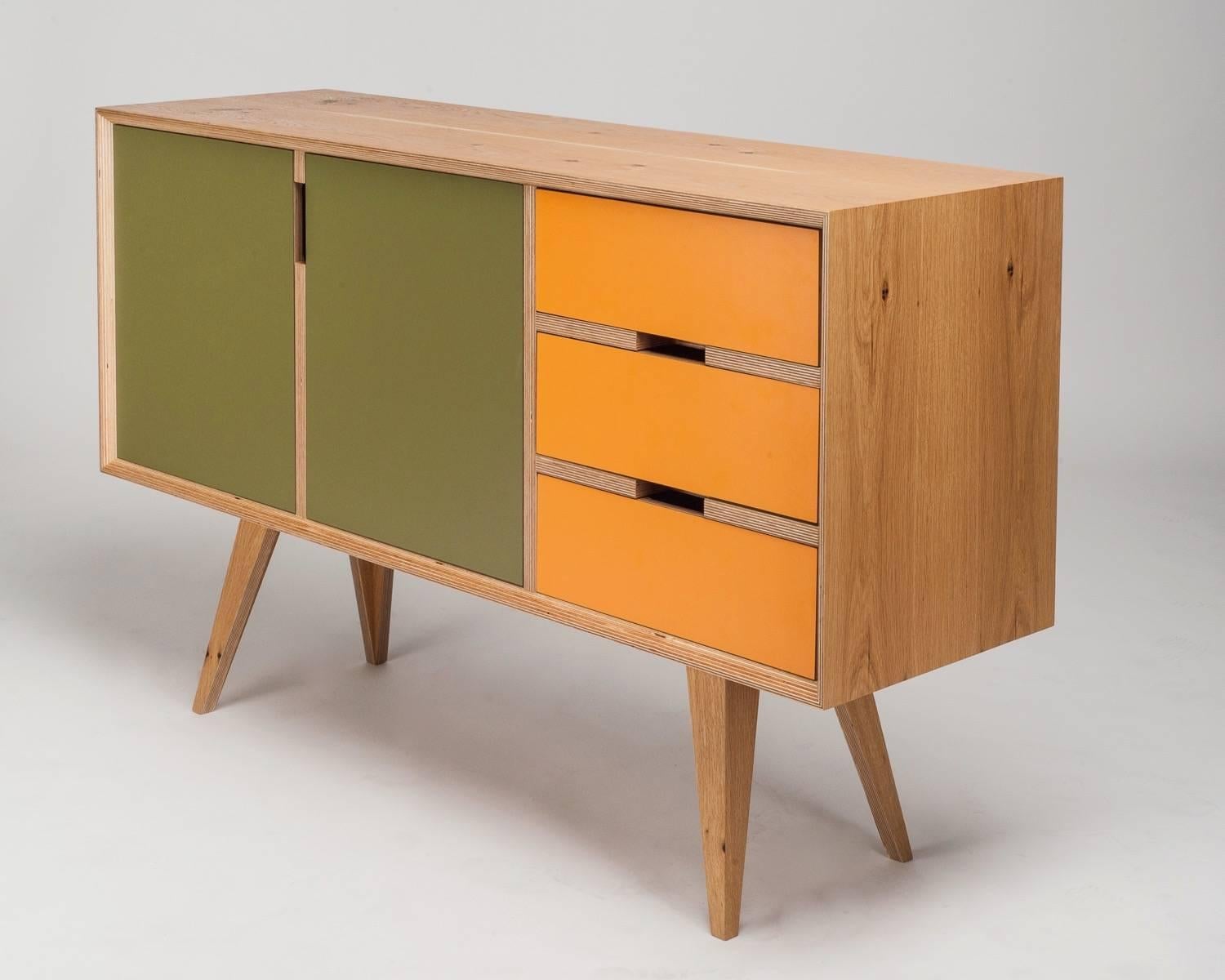 The Otto sideboard is handcrafted and made to order, so veneer finishes, colored door fronts and dimensions can be altered.
Seen here in European oak with olive green and yellowy orange. Please enquire for available colours.
