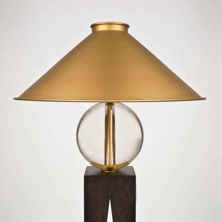 Louis Jobst' V lamp is composed from, a cone, a sphere and a triangle. Their proportions are carefully judged to create a harmonious formation, with each shape delicately balanced upon one another. The solid glass ball appears to be balancing as it