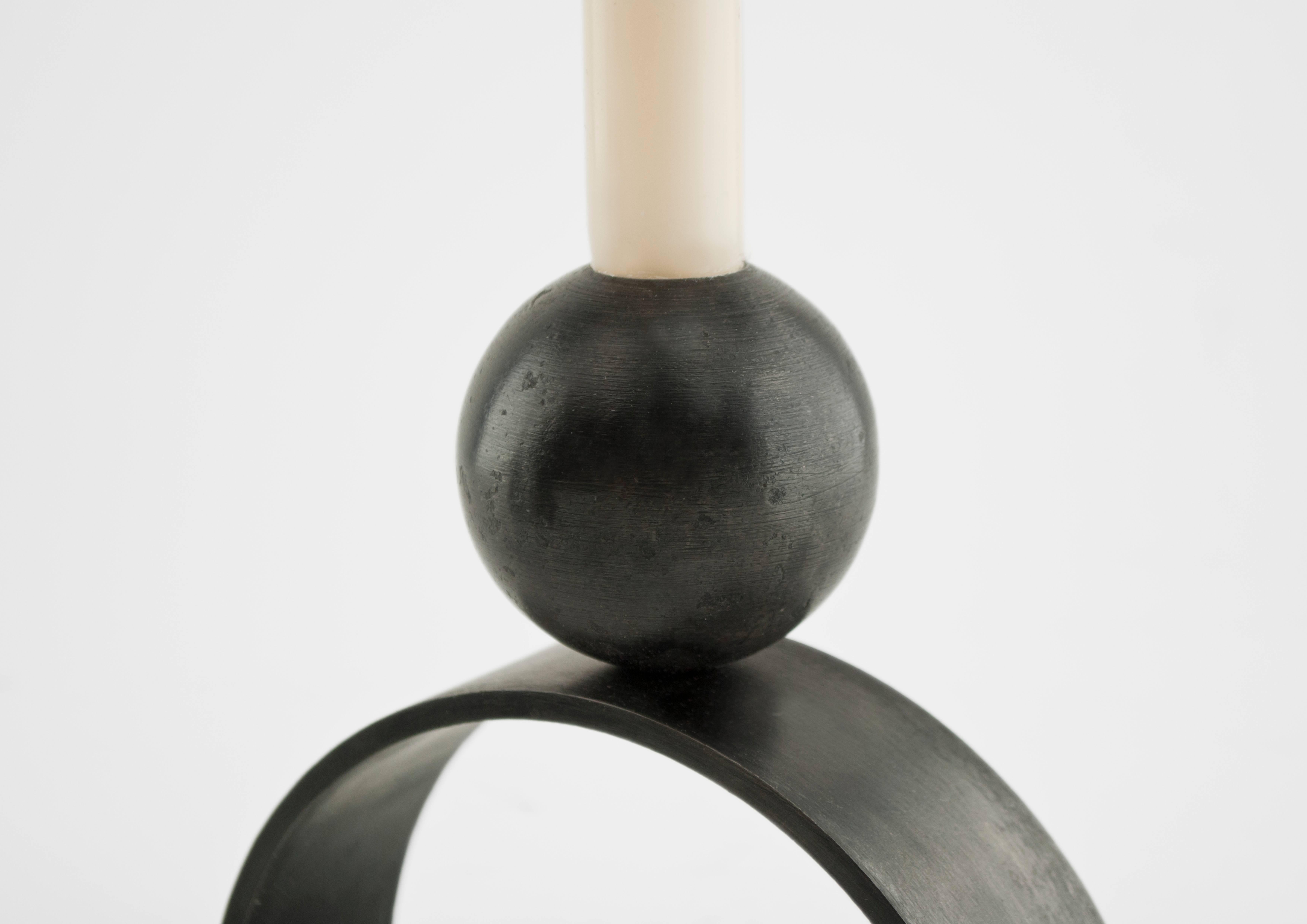 Louis Jobst' arch and ball candleholders are little monuments to have in the home. The form derives from paintings by Jobst of monumental shapes and forms.

Each candle stick holder is handmade from mild steel and patinated black. The contemporary