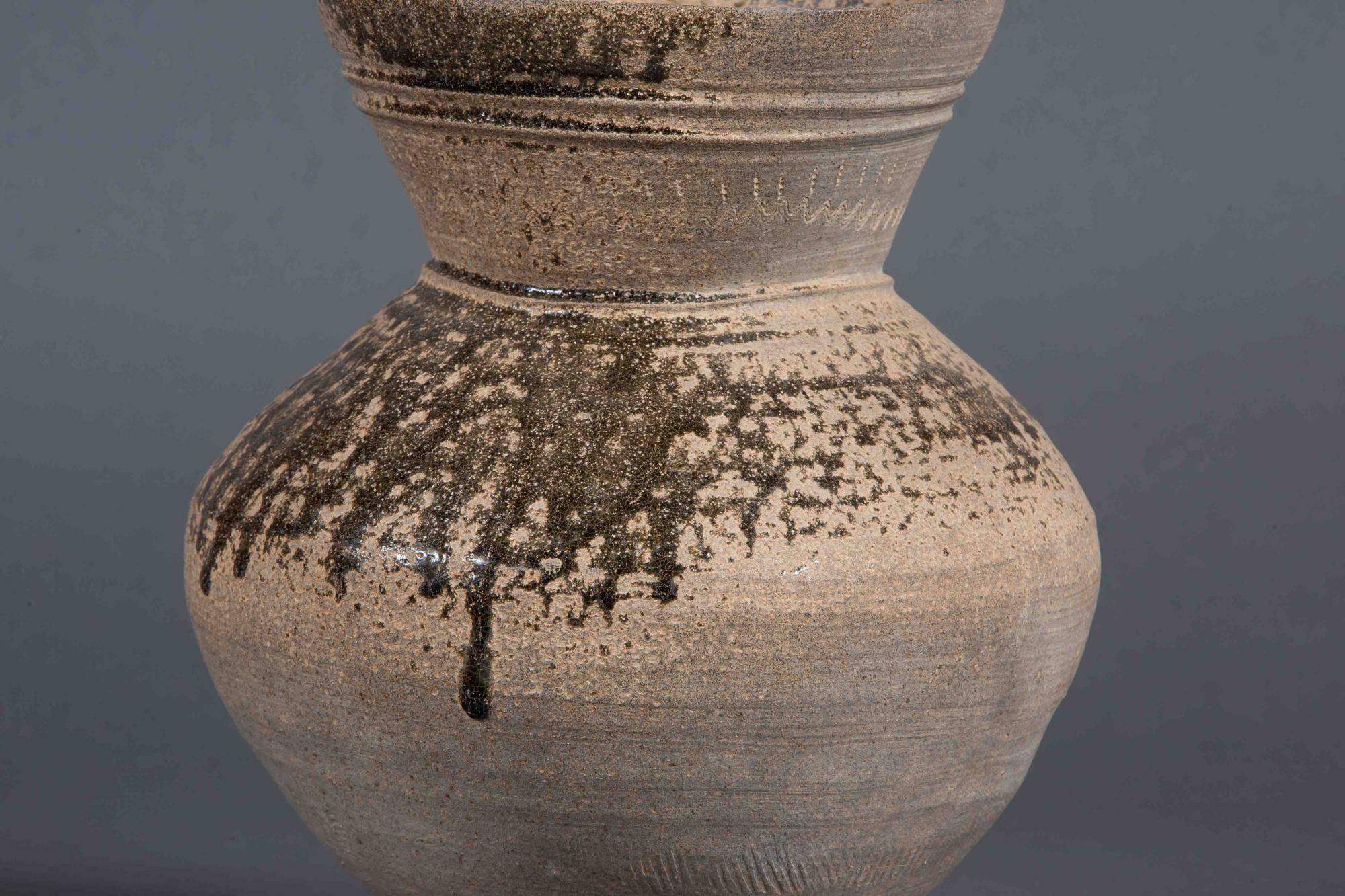 This Earthware Stand originates from the Three Kingdoms period, Silla Kingdom (57 B.C.–A.D. 676) of Korea.  5th-6th Century

Silla pottery may well be the most genuinely indigenous of all Korean art forms.  It varies from the near-primitive to the