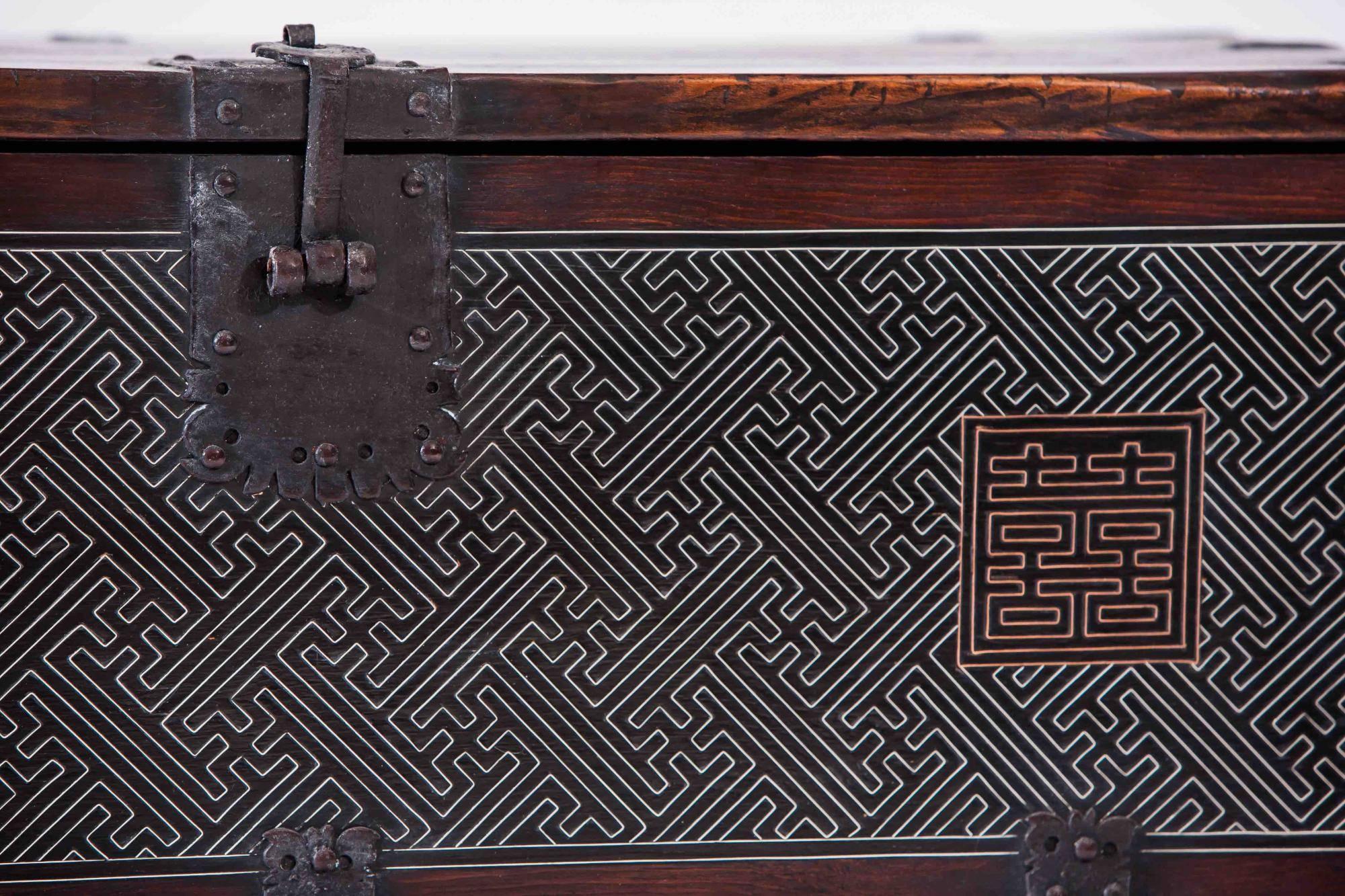 Korean Chest Yi dynasty limewood silver inlay brown storage cabinet, 19th century
This blanket chest or Bandaji is constructed of lime wood with delicate silver inlay throughout the front. The black rectangular lock plate secures the chest and thick