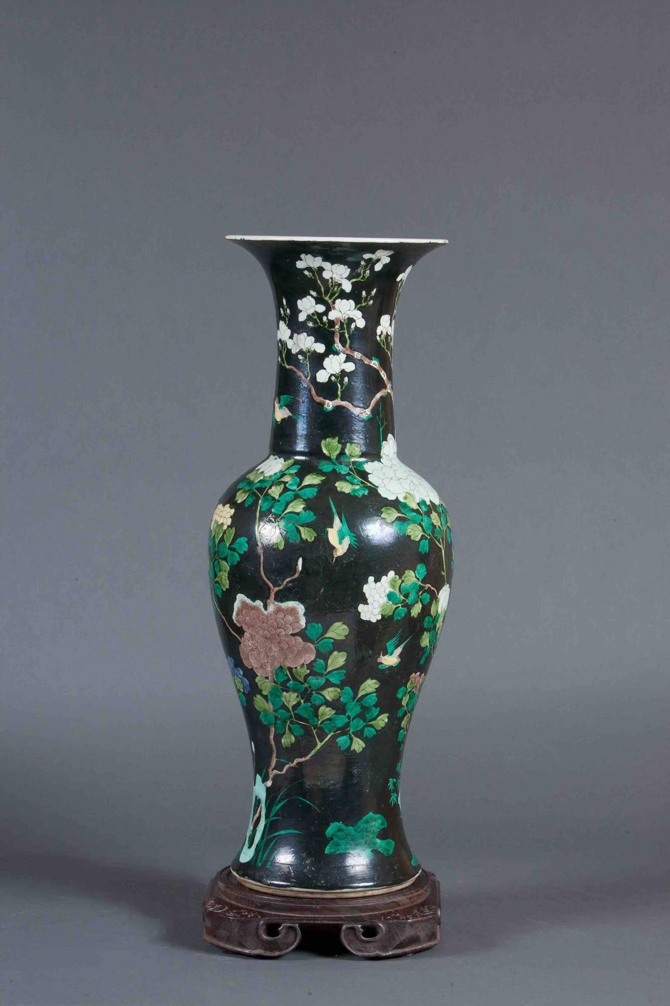 Famille Noire enameled yen yen vase
This ceramic Chinese vase depicts flowering trees, birds, and flowers set against a strong dark green background. It comes with the Stand you see in the photo. It will make a statement on any surface you set it