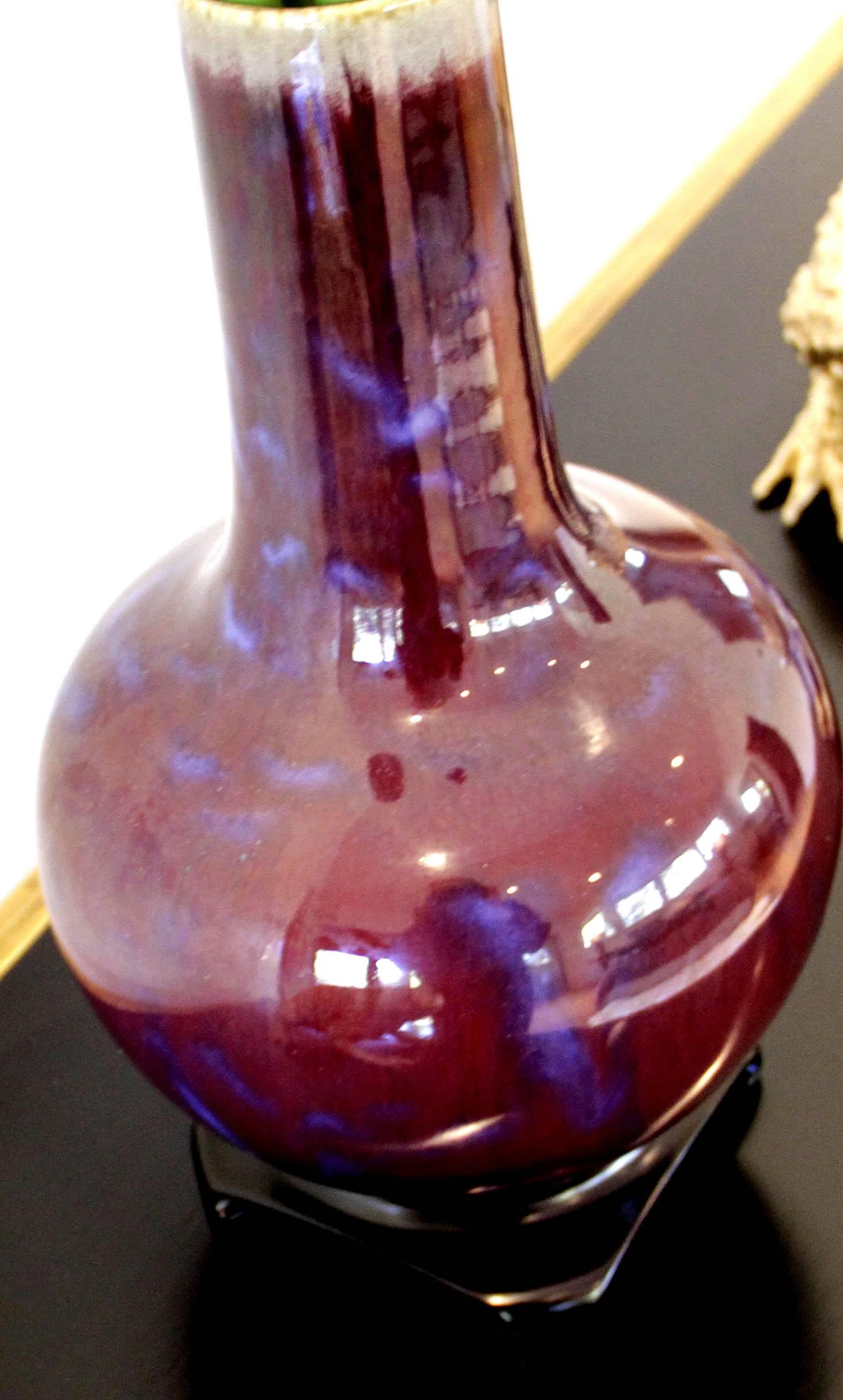 This vase from China dates back to circa 1908, from the Ching dynasty, Kwang-Hsu period. It is an excellent example of the pottery technique and color called oxblood. It comes with a wooden carved stand. Shown in additional photos are other items we
