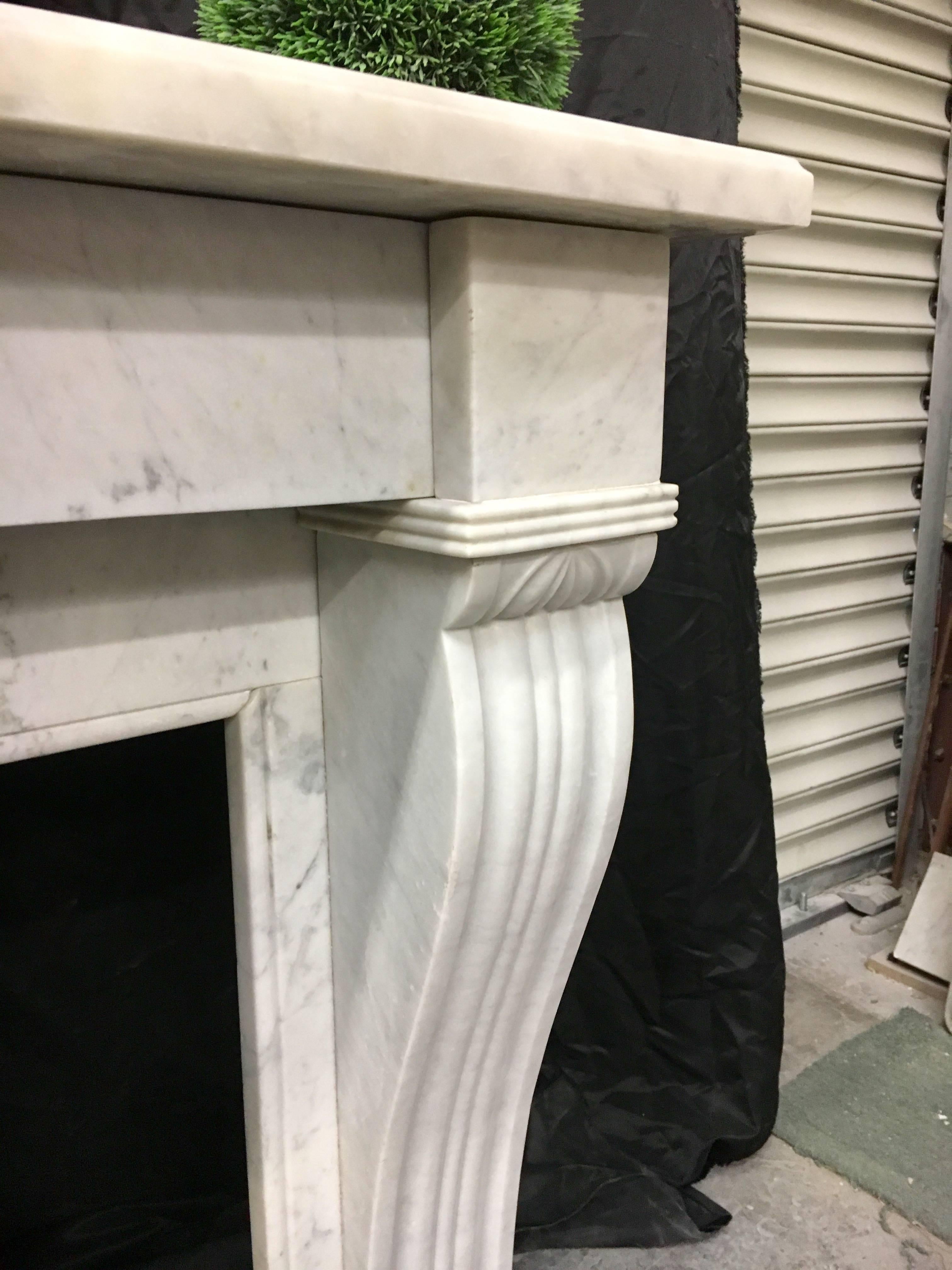 A fine and fully restored antique Carrara French marble fireplace with large sweeping corbels to legs.
French 1880c
Fire Opening size: 34' wide x 27 3/4' high. 