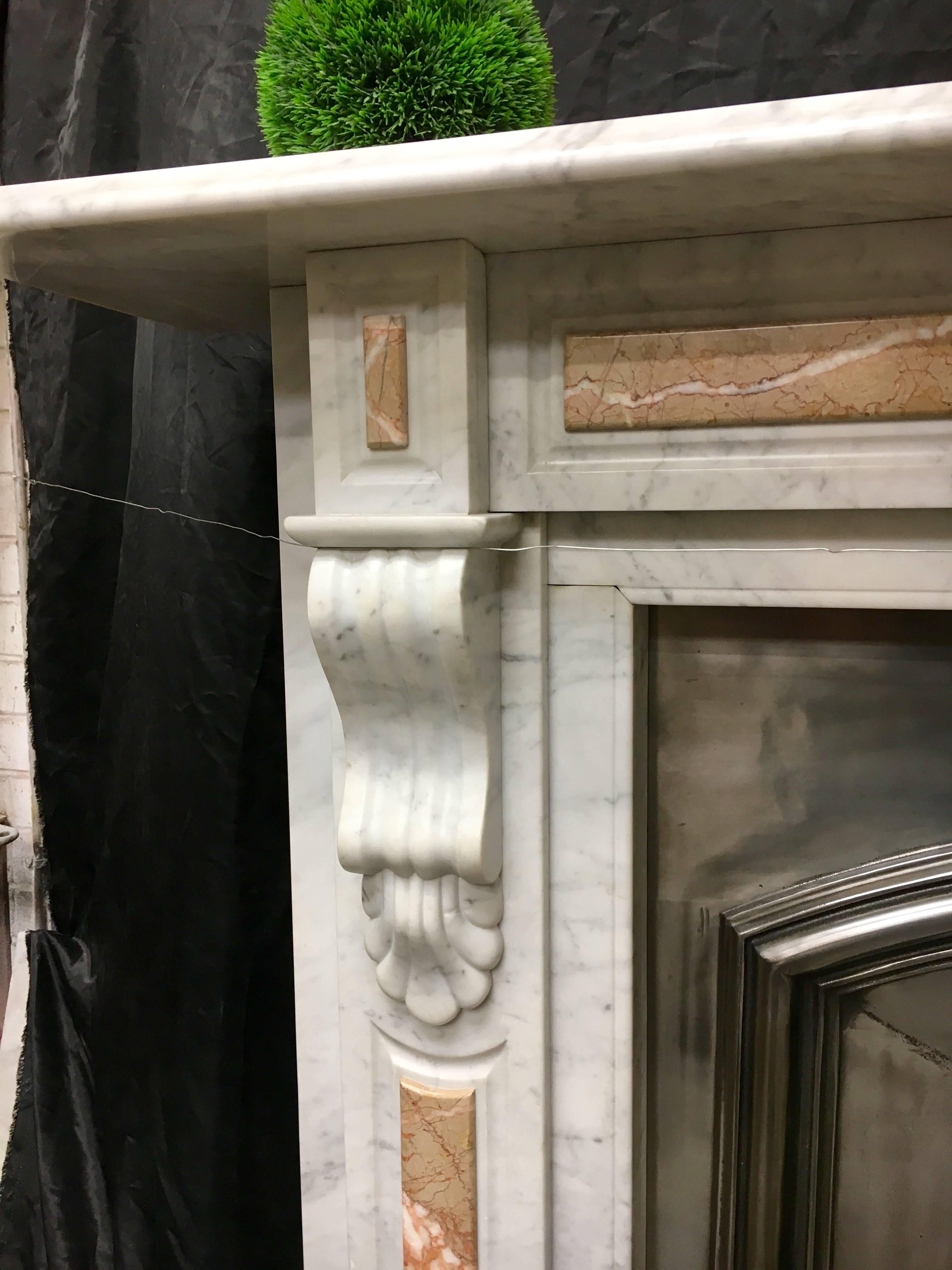 A large and attractive Carrara marble fireplace with raised panel's in Breccia Traccagnina. This rare marble is found in the Scalpellini of Rome, larger samples can be found of this stone in two pillars in the 18th century monument to Mariano