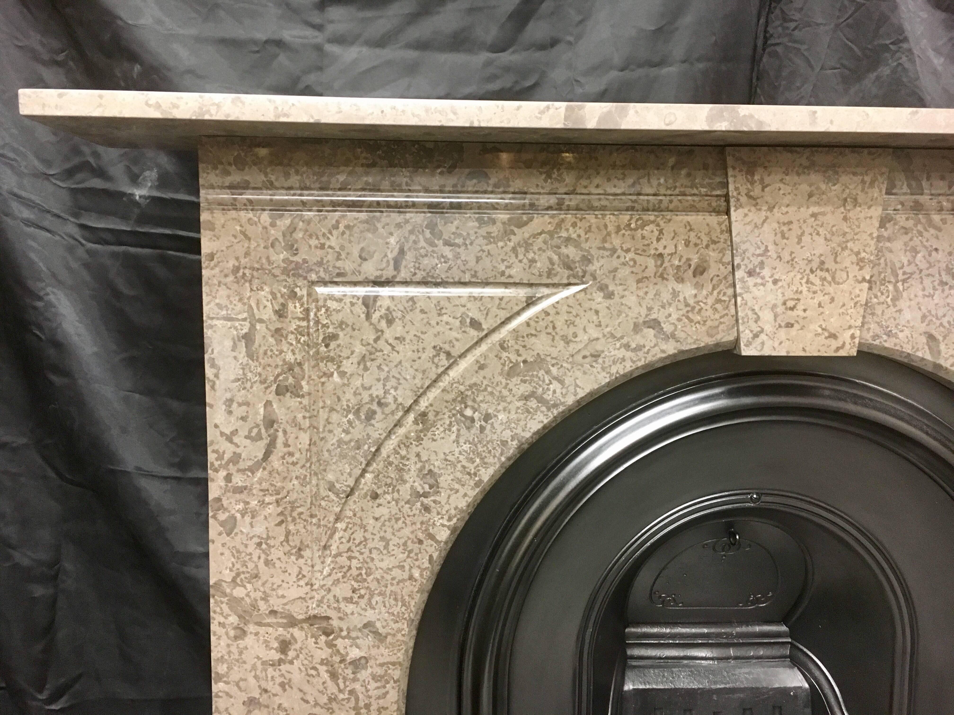 A simple but pleasing Antique Late Victorian arch spandrel fireplace surround, in Derbyshire Fossil Marble, complete with its original cast iron arch insert, all fully restored and ready to install. Late 19th Century, English. 

Fire opening size: