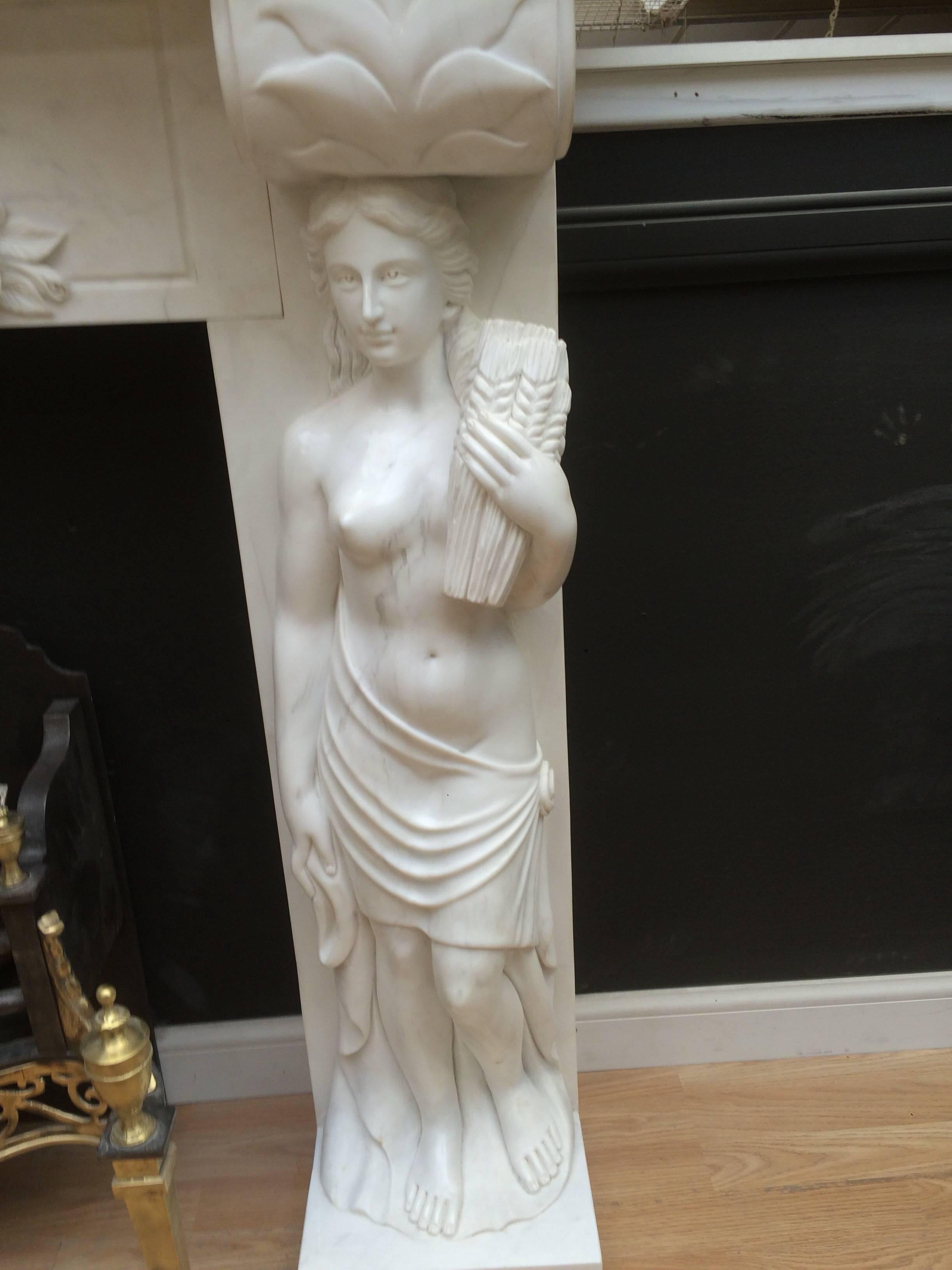A detailed and well carved statuary marble Fireplace Surround and cast iron insert, showing good, detailed carving throughout. Comes with its cast iron insert, ready for a gas fire or you could convert to solid fuel. A reproduction piece, probably