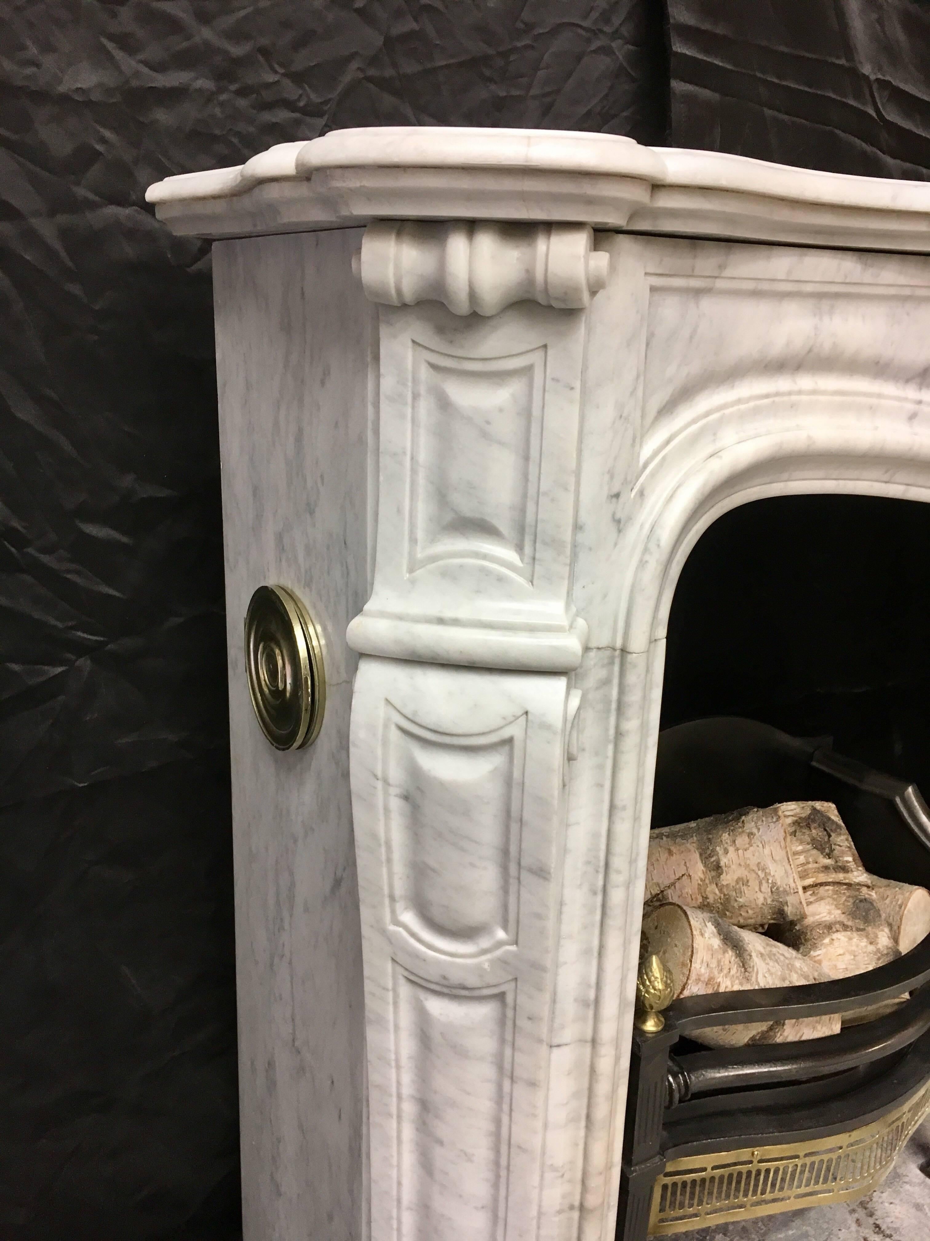 A clean and fully restored Antique French Carrara Marble Louis XVI carved fireplace, with its original brass flap vents on each side.
French, 1880.

Fire opening size: 890mm high x 780mm wide.