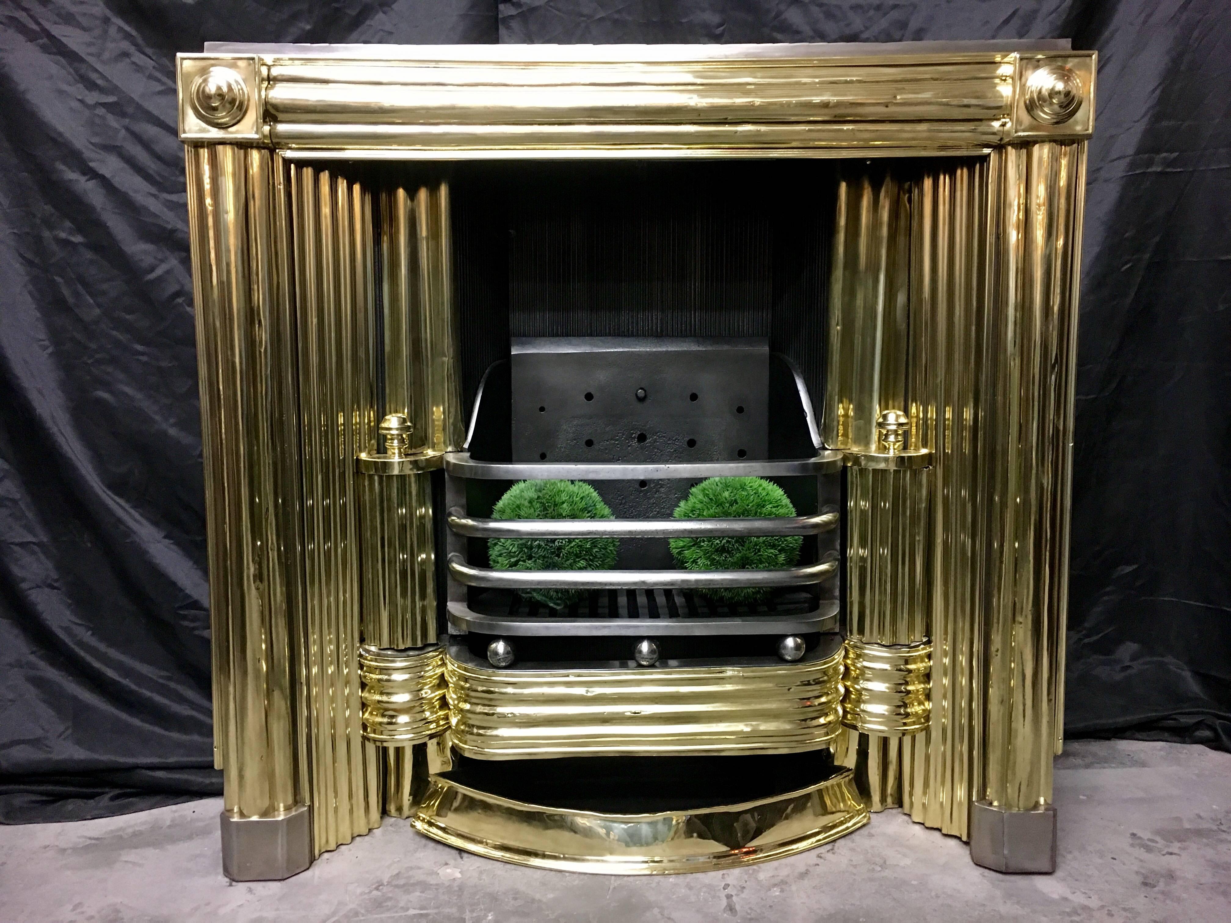 A fine and rare 19th Century Regency fireplace Insert grate, salvaged from Anne Street, Edinburgh Scotland. Circular rondel's to capitals with raised reeded brass fronts and fret. Polished brass reflector plates, with its original ash pan.