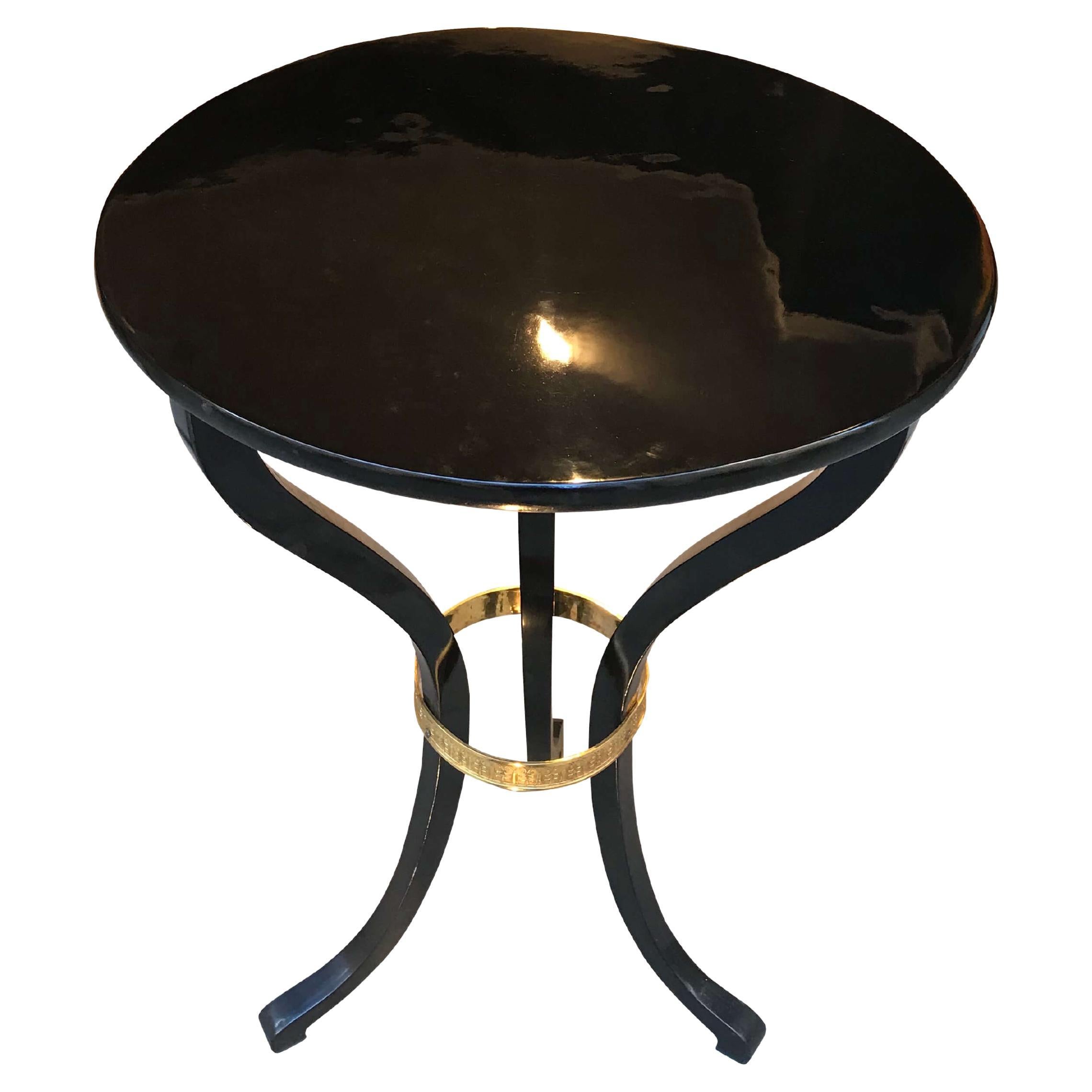 Elegant ebonized Empire side table from Vienna, Austria, circa 1815. 
Black polished (ebonized) maple solid wood. 
Three elegantly curved legs with finely chased original brass ring.

