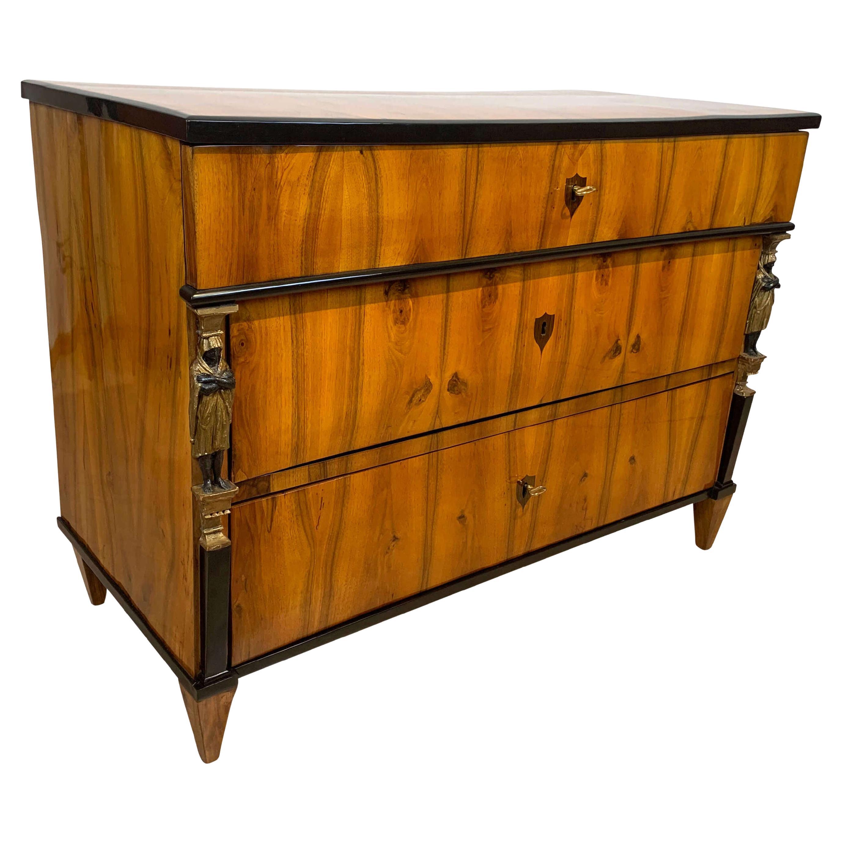 Very fine original Empire commode or chest of three drawers, walnut veneered with Caryatid pilaster columns, from Austria/Vienna about 1810-15.
 
Lovely book-matched Walnut Veneer on softwood. Excellent french polished surface.
Exceptional carved