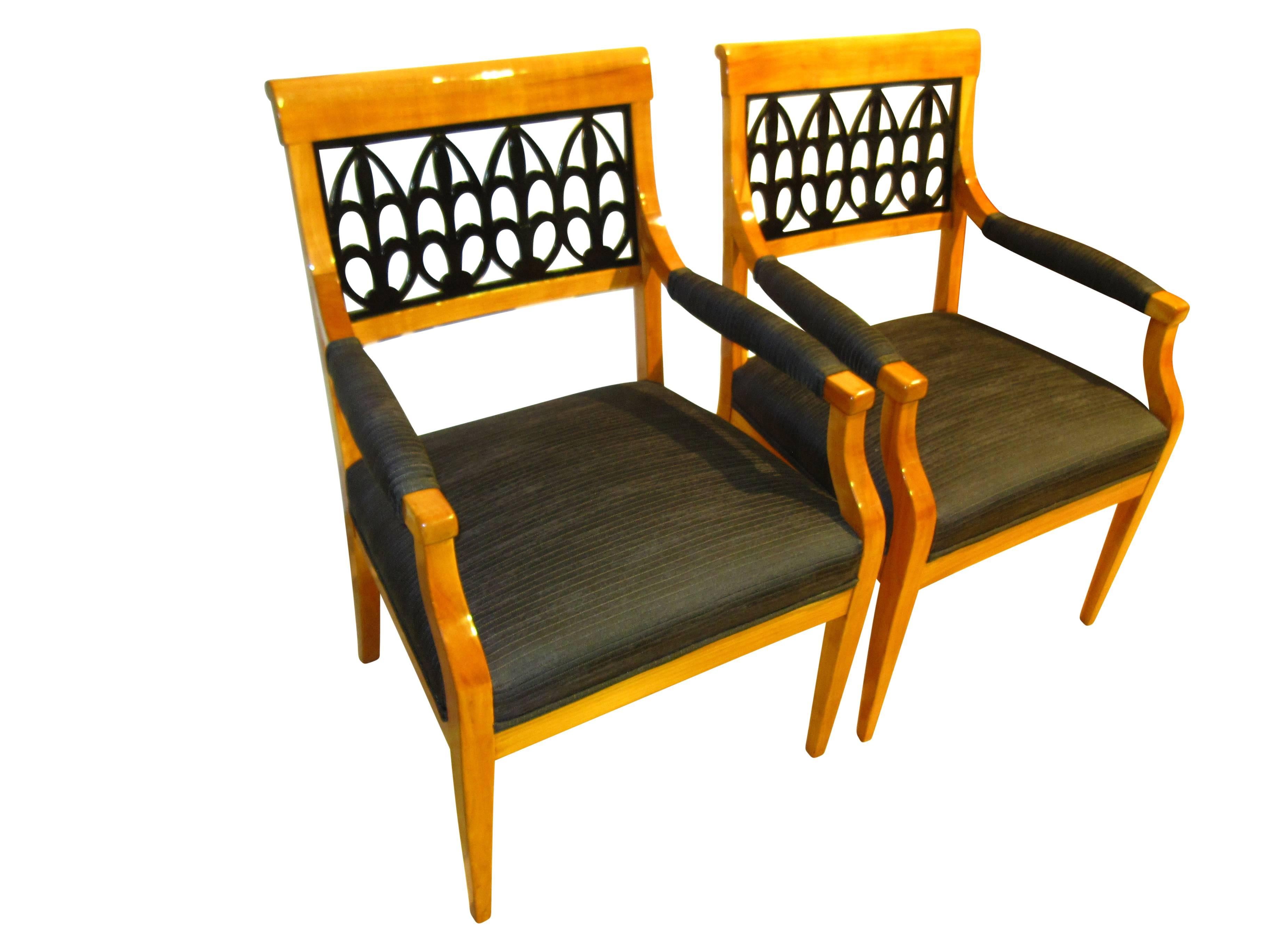 Extraordinary beautiful pair of original Biedermeier armchairs in cherrywood, circa 1830. The wood has been hand-polished (French polish) with shellac for a very precious high-gloss. The big back decor is completely original and made from blackened