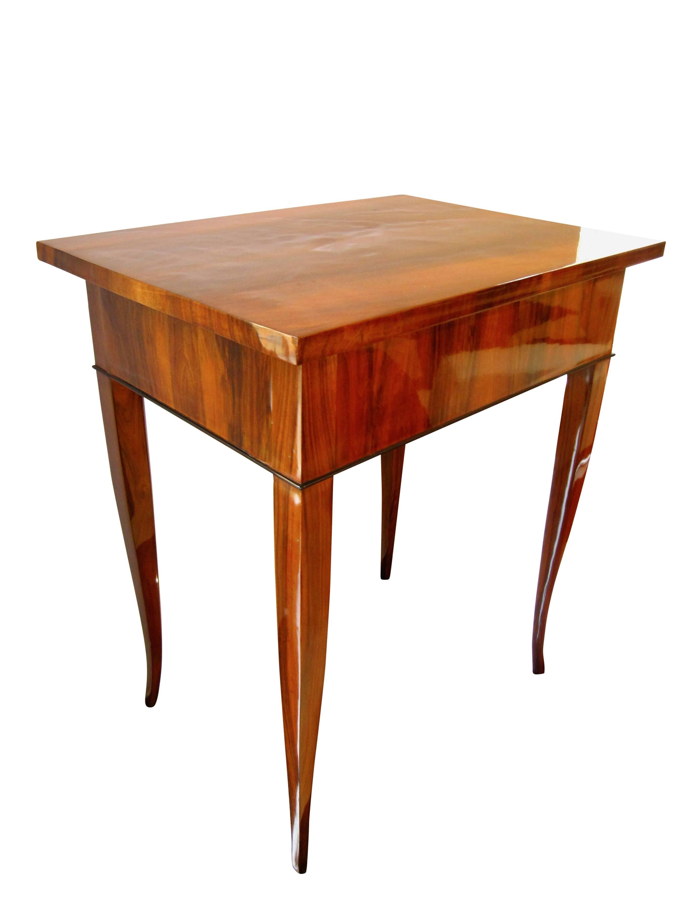 Simple, early Biedermeier side table with walnut veneer and elegance legs.