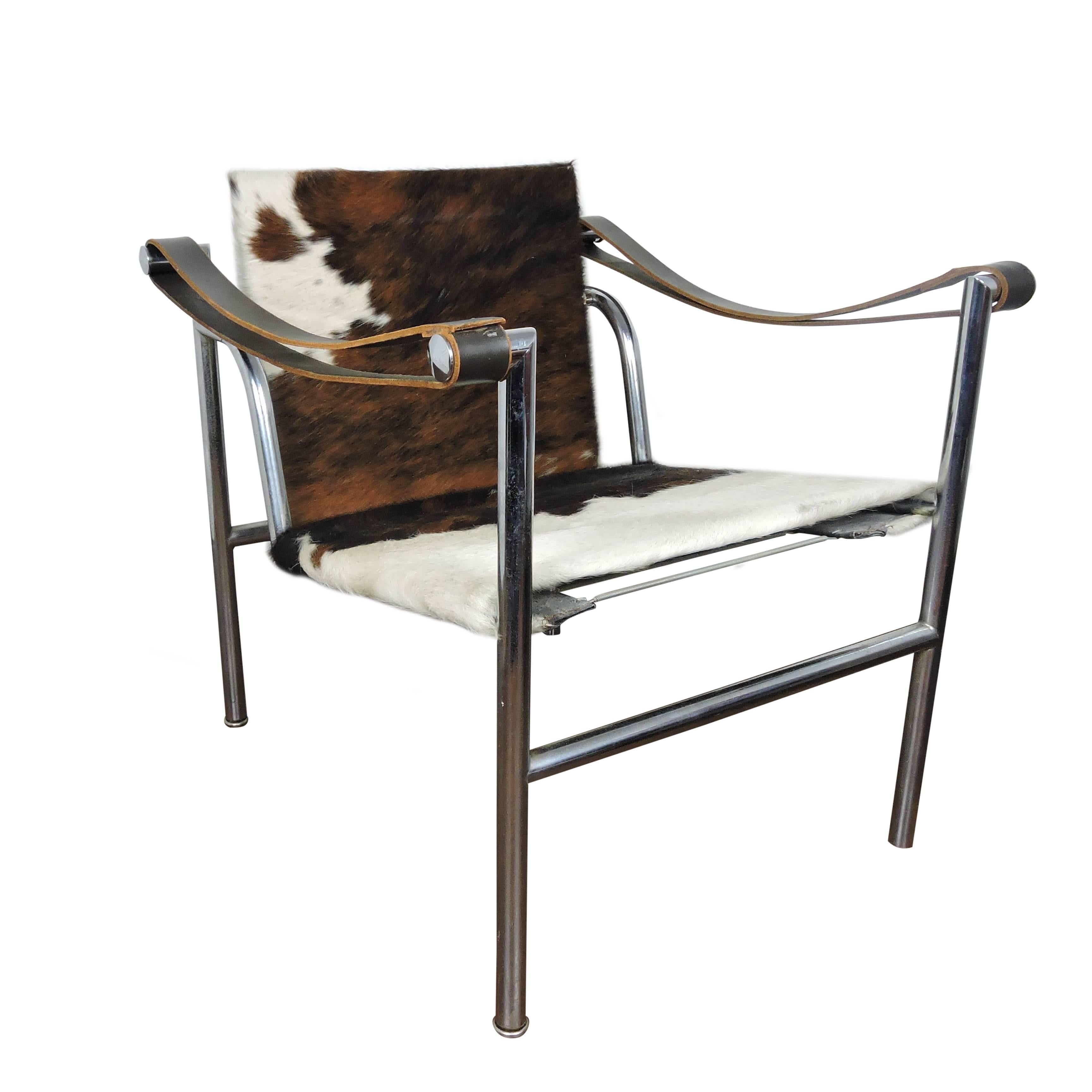 Italian Mid-Century Modern Le Corbusier cow-hide chair with chrome frame. Features leather arm rests and adjustable back. LC1 lounge chairs designed by Le Corbusier, Pierre Jeanneret & Charlotte Perriand and produced by Cassina. Signed no.