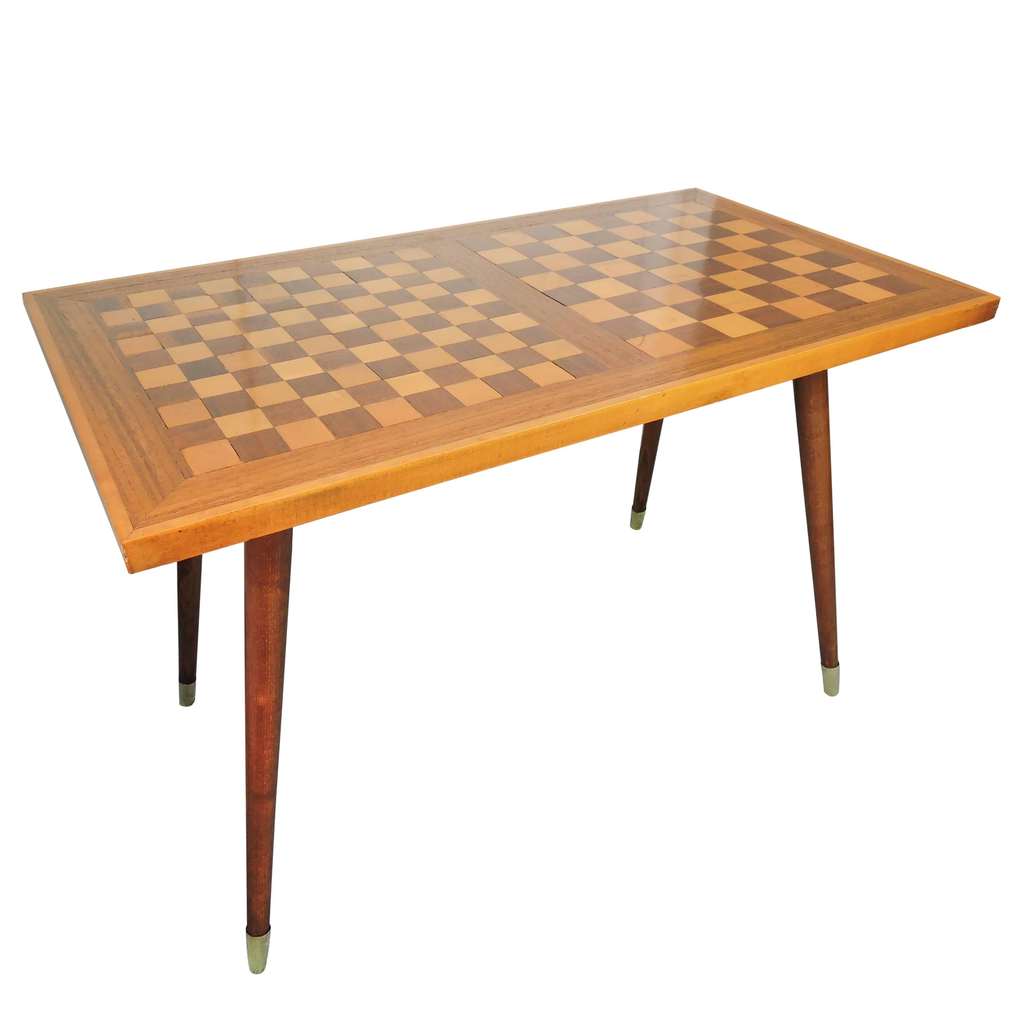 This side table with top for chess playing is made of different types of wood and with tapered turned brass topped legs. The chess board remains in very good vintage condition.