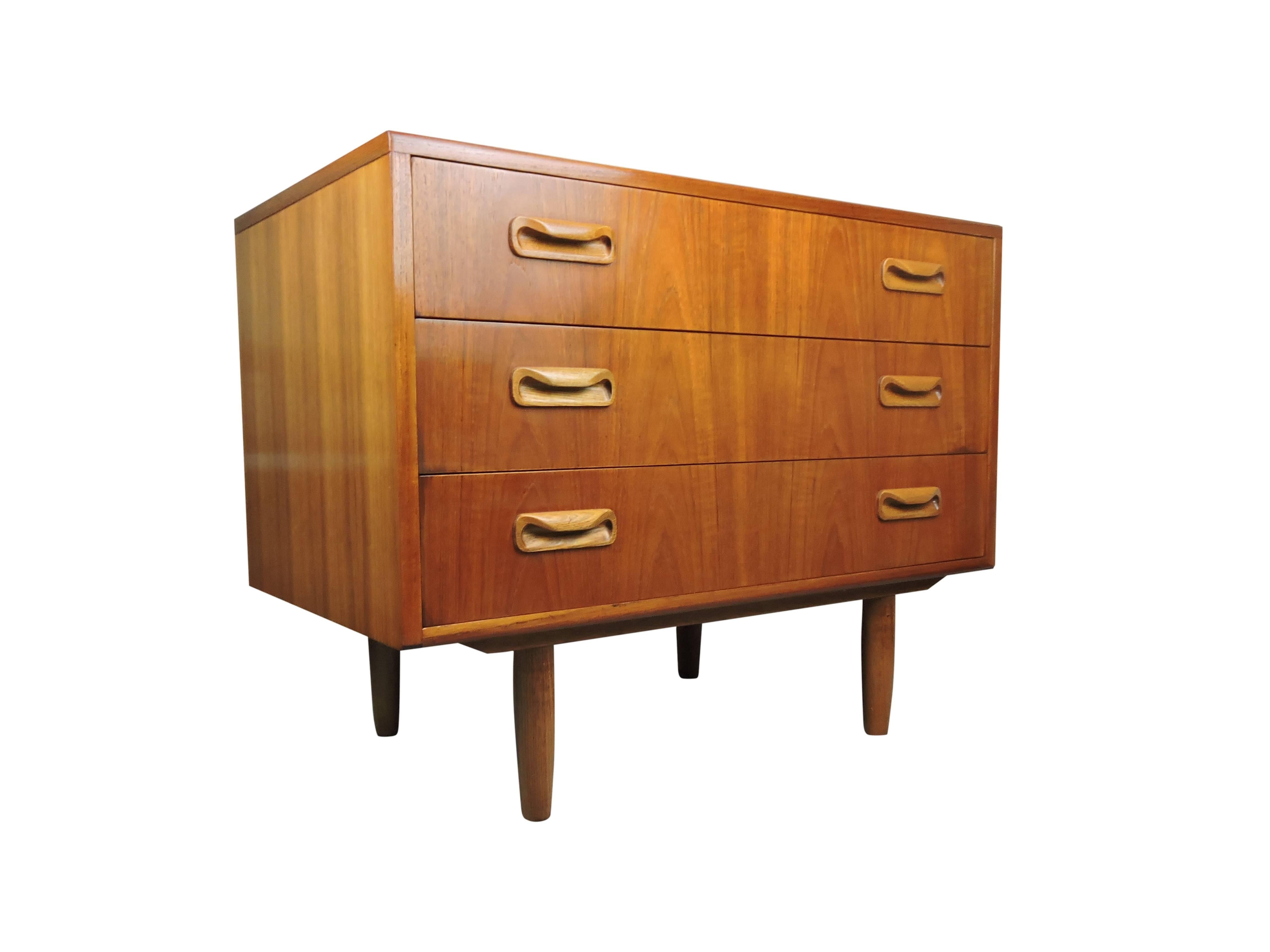 A G-Plan teak three-drawer chest standing on four turned legs.