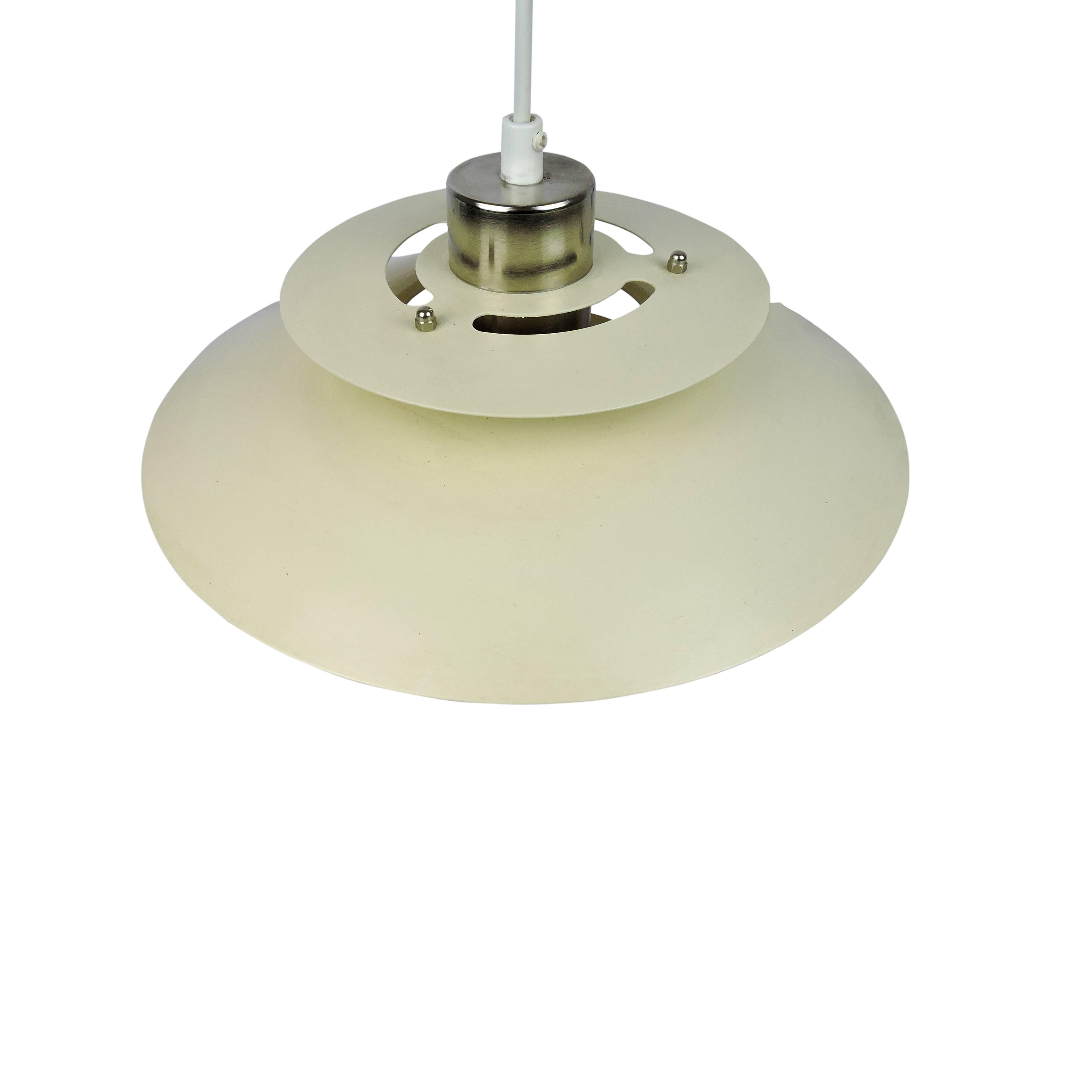 A Danish pendant light featuring a metal curved discus shape in ivory with exposed chrome.