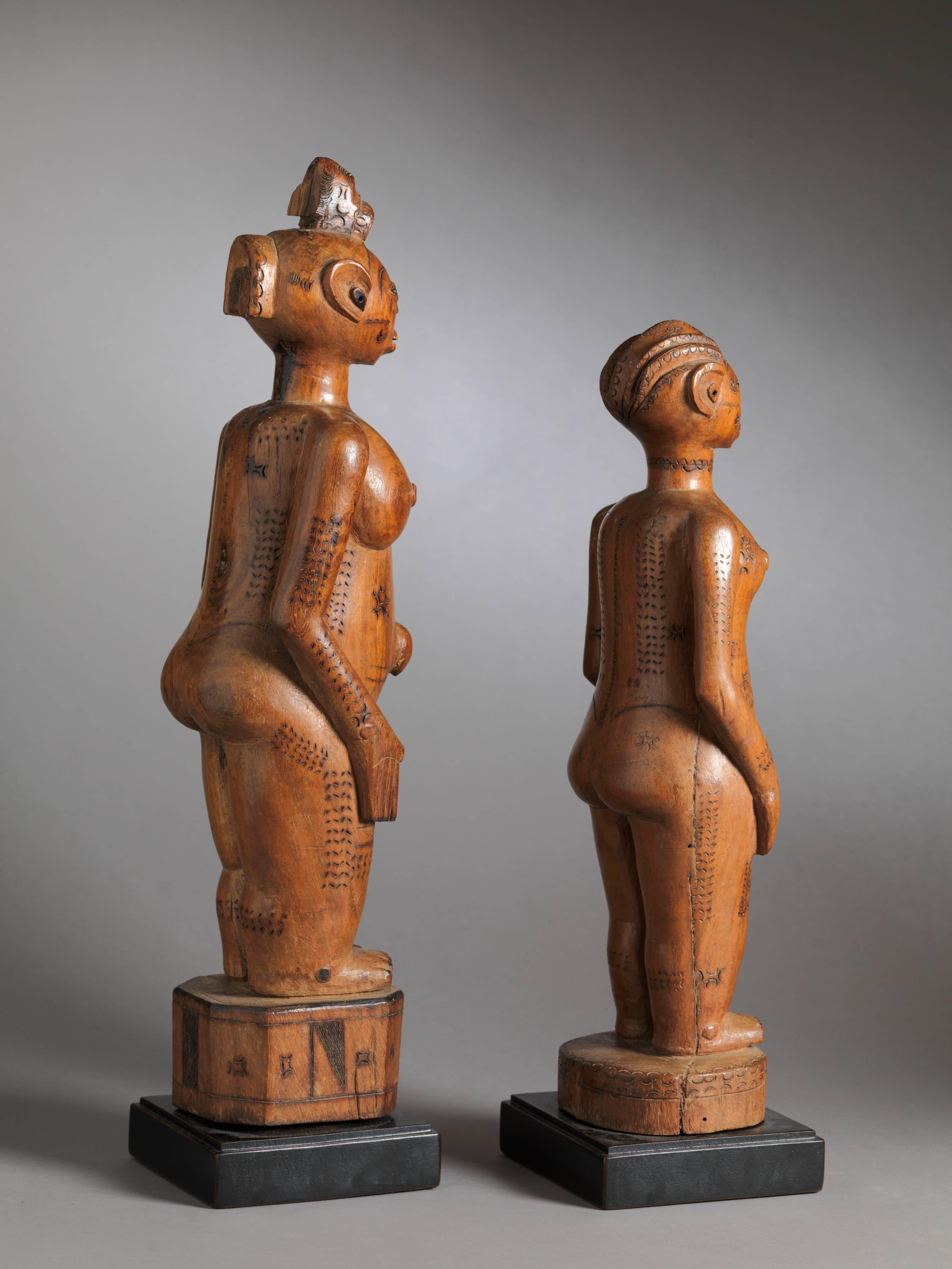 Exceptionally refined and rare Zela couple in medium dense yellow colored wood with a clear shiny patina. The sculptures' cap-like hairstyles are typical for the Zela as are the ritual scarification’s on the front and back of their bodies. Apart