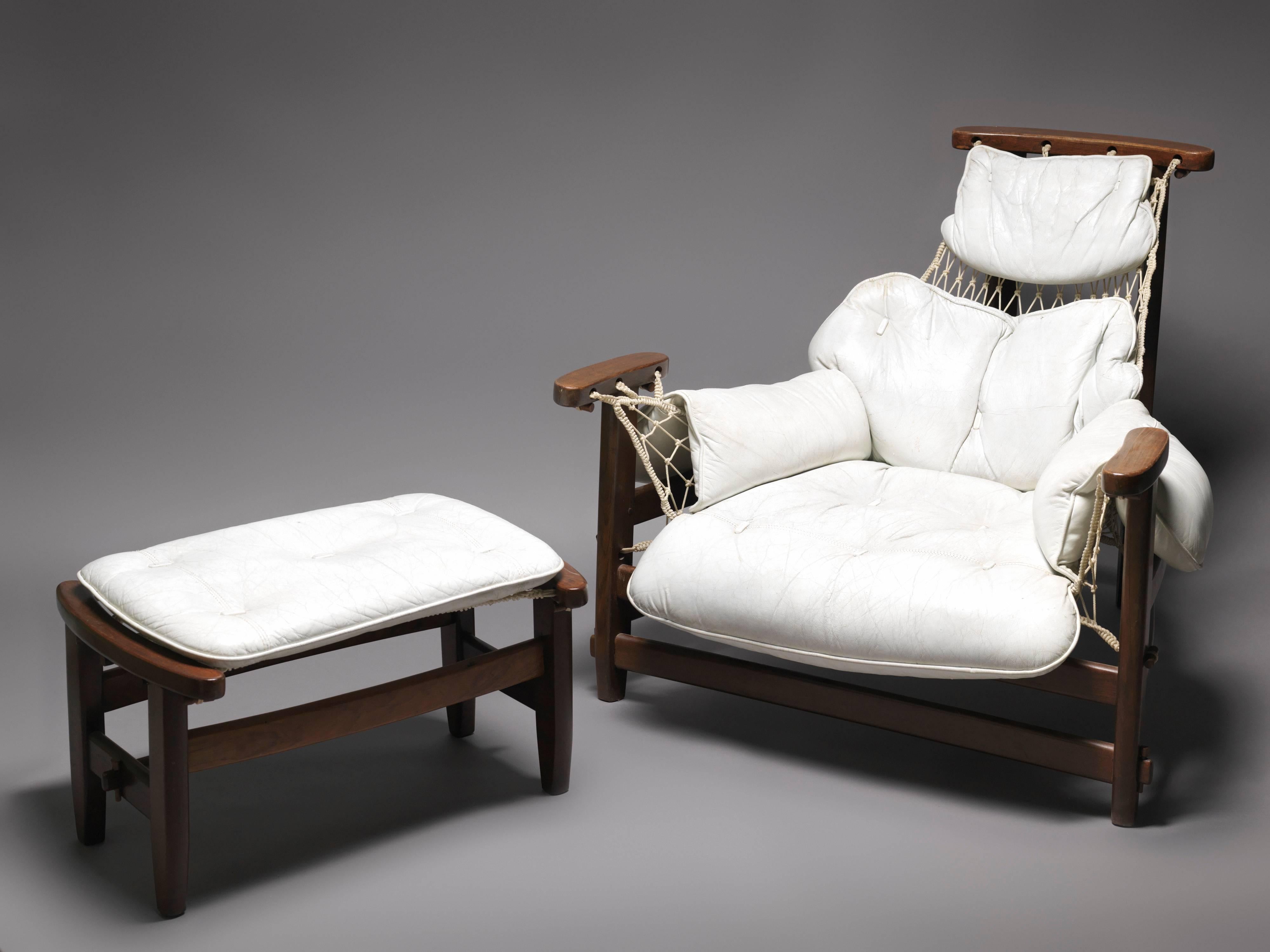This fabulous easy chair was designed by Jean Gillon for Wood Art, Brazil in 1962. This amazing chair is made of organic shaped Jacaranda wood and has a rope seat that resembles a fishing net. The seats of the armchair and ottoman are filled with