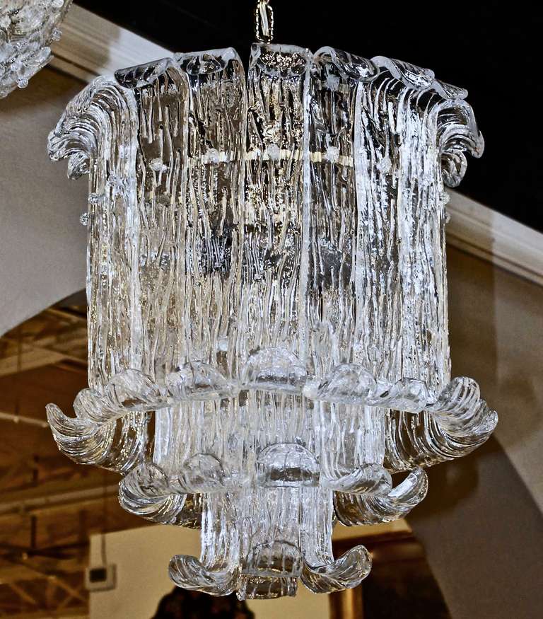 Beautiful Italian thick handblown curved textured glass chandelier by Mazzega. Steel metal frame uses seven 60-watt A size bulbs, newly wired for US. Chandelier size 22