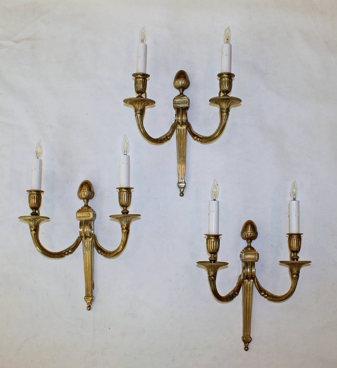 Set of three Louis XVI style bronze or brass two-arm wall sconces, by Maison Baguès, Paris, style # 9271. Newly wired for US. Retains original Baguès foil label. 

Measures: 10-3/8